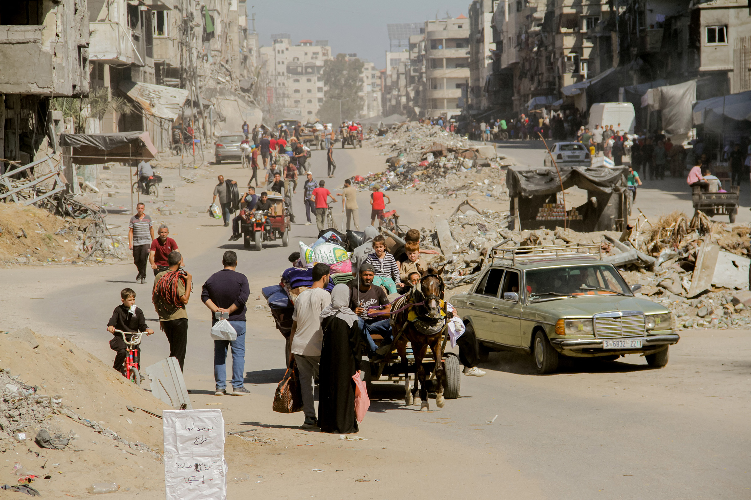 Palestinians carry their belongings as they flee areas north of Gaza City in the northern Gaza Strip on Oct. 12, 2024.