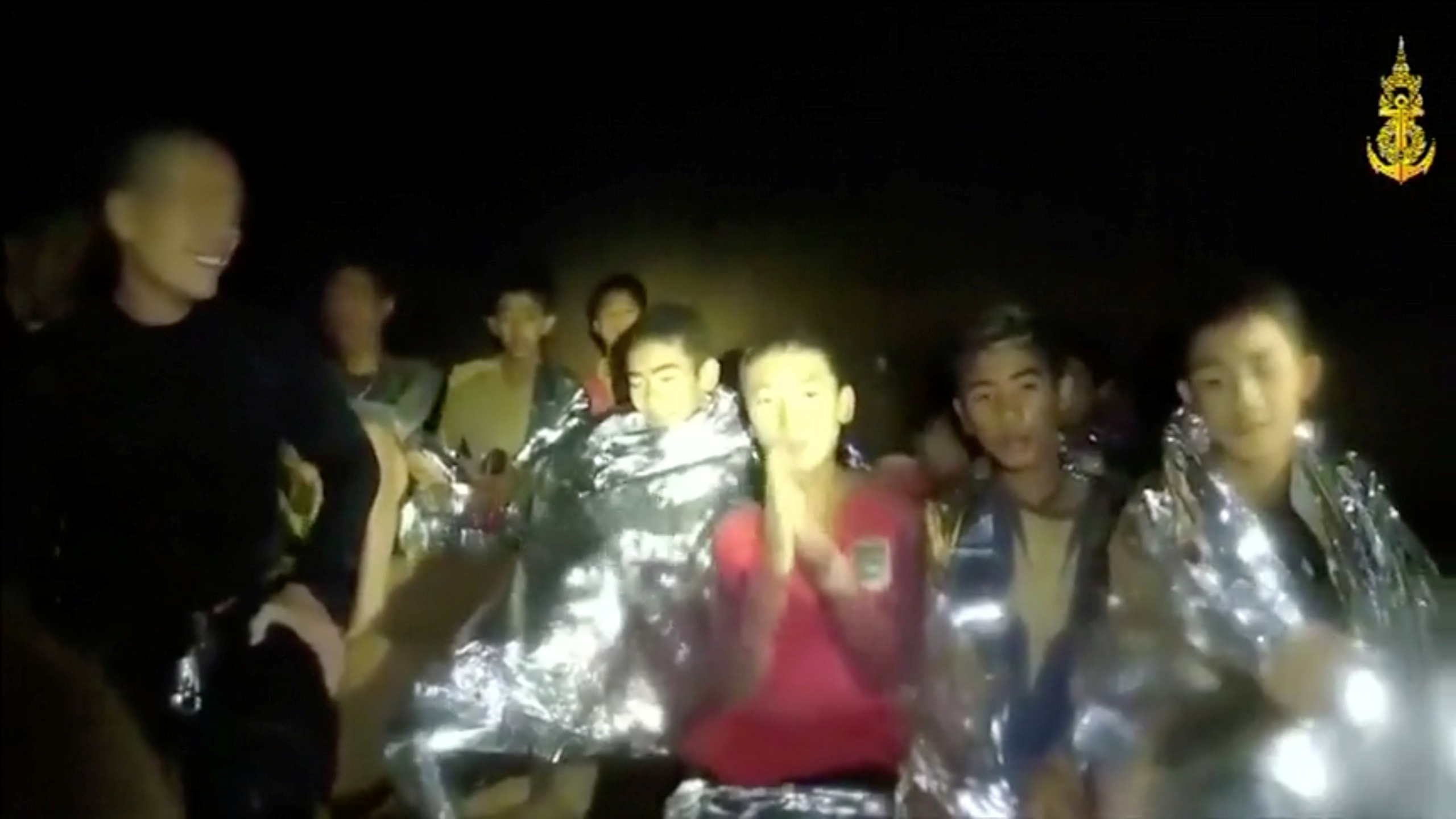 Boys from the under-16 soccer team trapped inside Tham Luang cave greet members of the Thai rescue team in Chiang Rai, Thailand