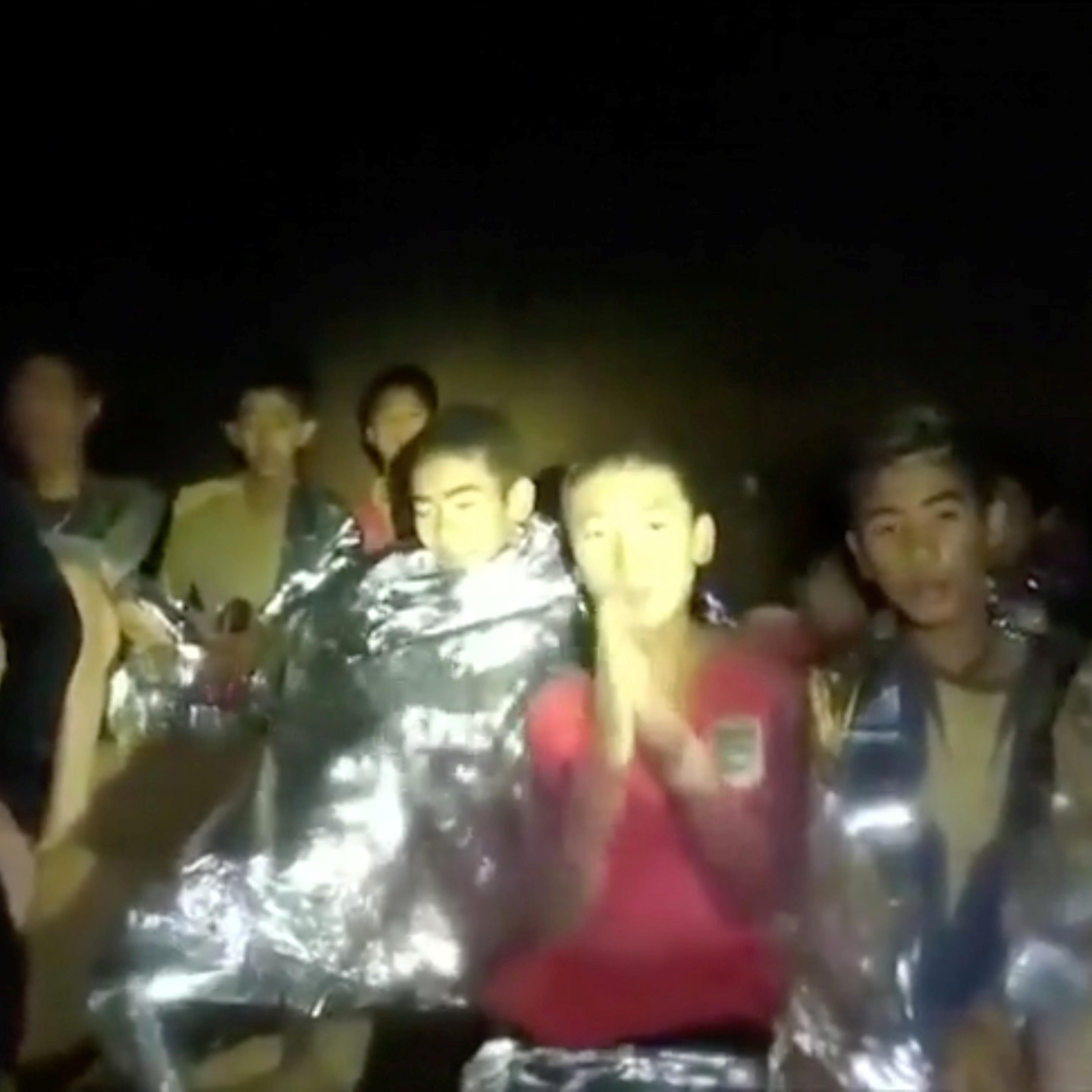 Boys from the under-16 soccer team trapped inside Tham Luang cave greet members of the Thai rescue team in Chiang Rai, Thailand