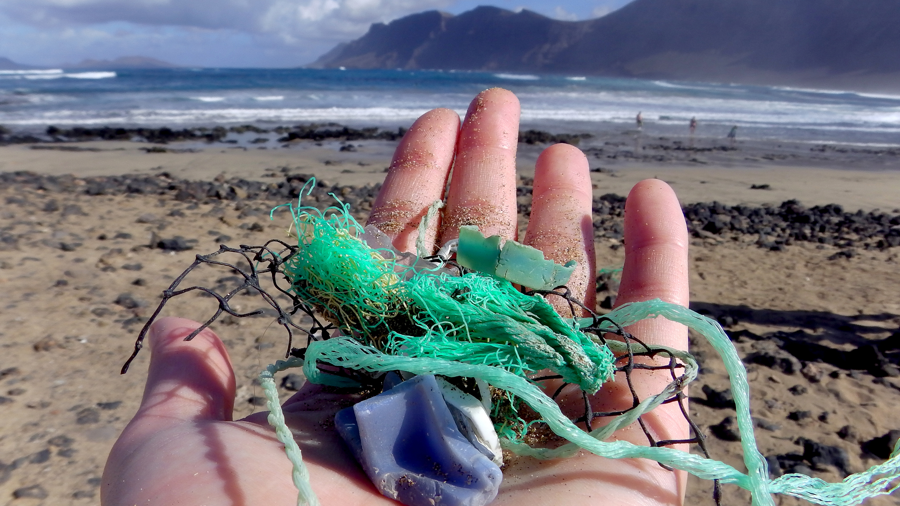 Study author Jenna Jambeck of the University of Georgia collects plastic samples from a beach near Caleta de Famara, Canary Islands, Spain.