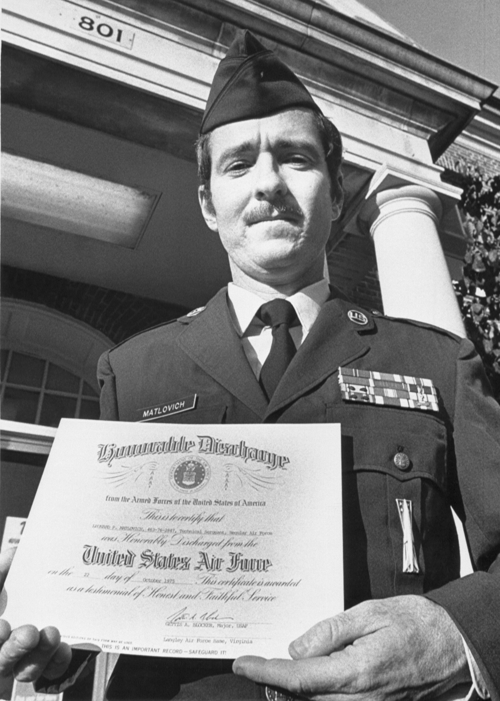 A United States Air Force Sergeant holds his Honorable Discharge papers in 1975. He was discharged from the service because he was gay