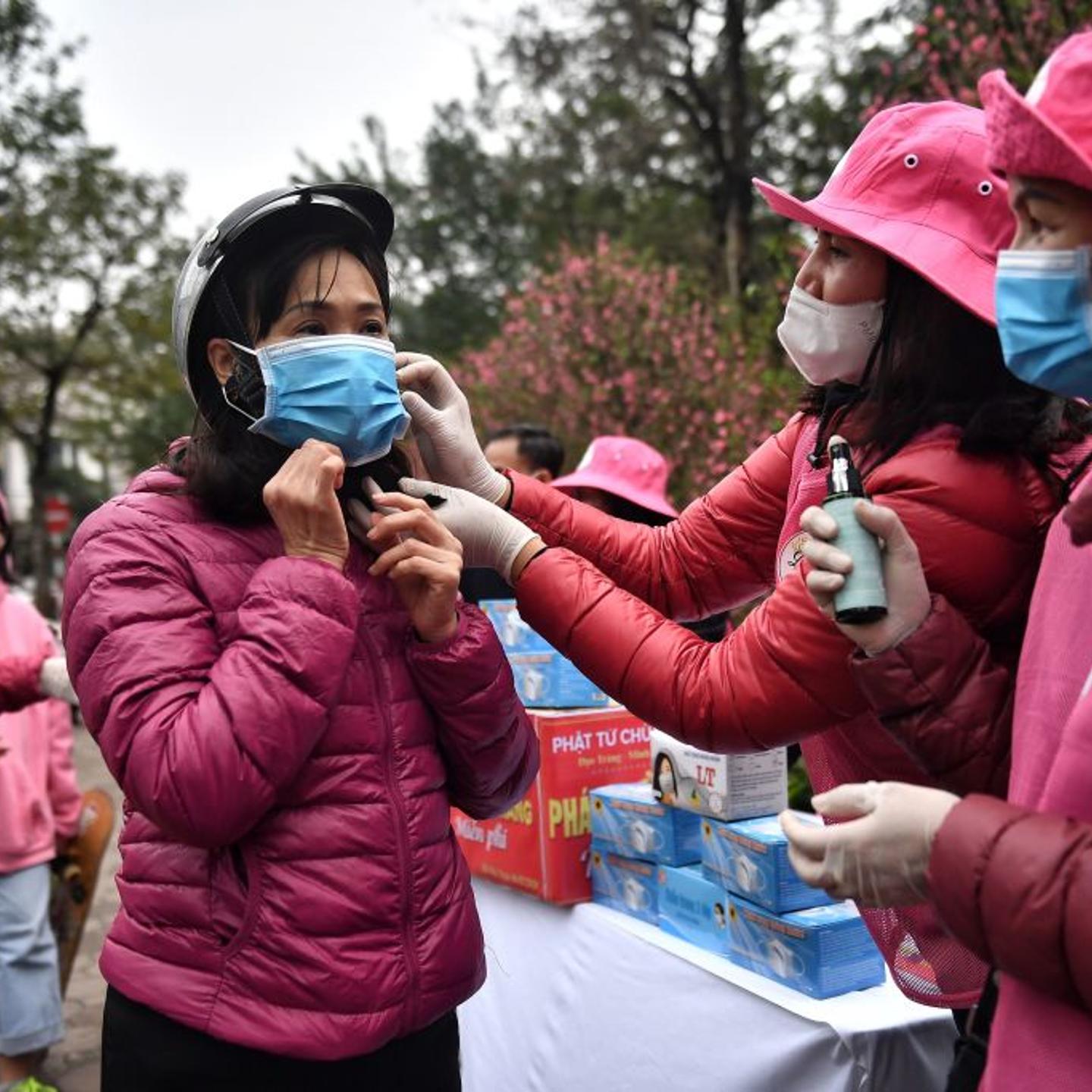 Volunteers hand out face masks in Hanoi, Vietnam.