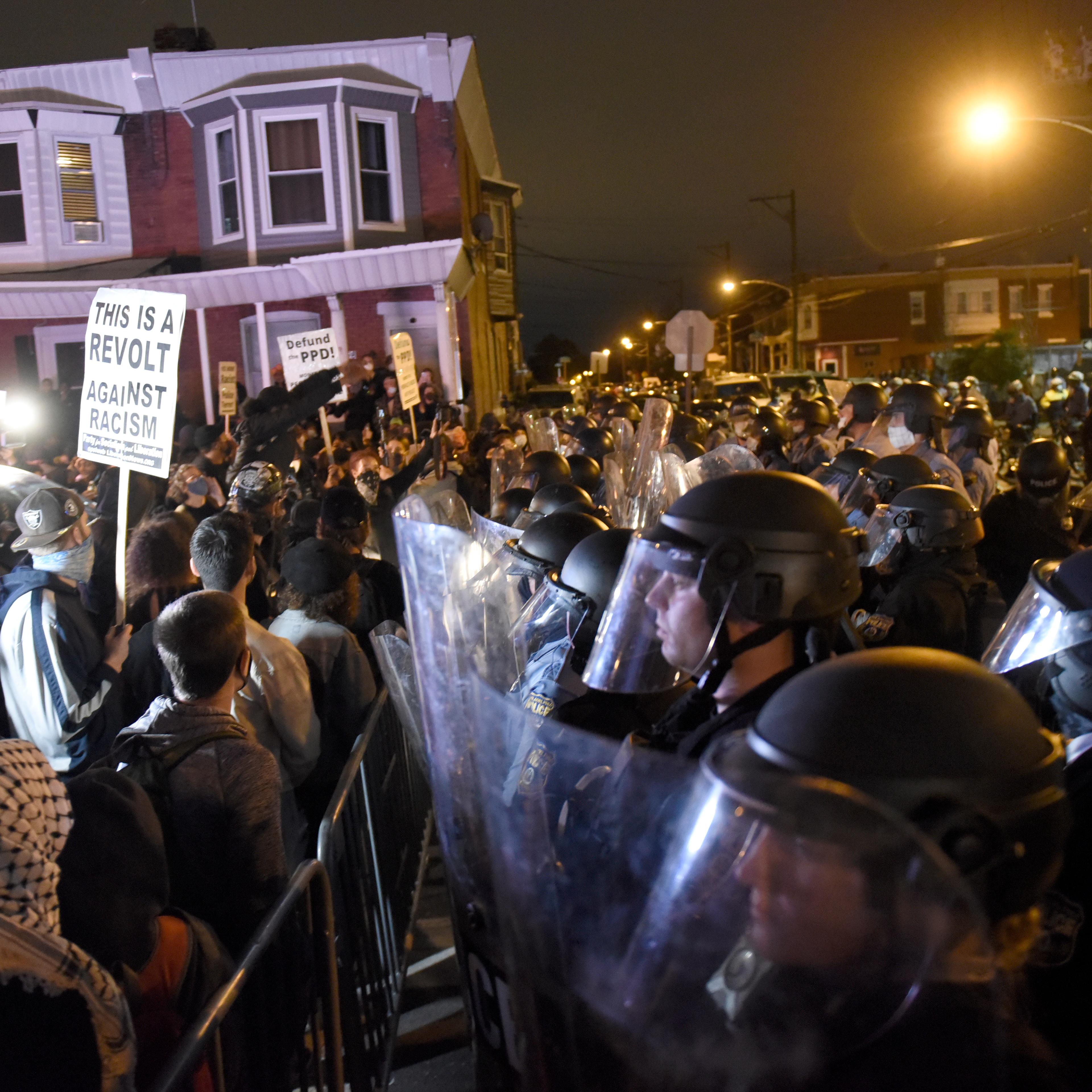 Protesters face off with police during a demonstration Tuesday, Oct. 27, 2020, in Philadelphia