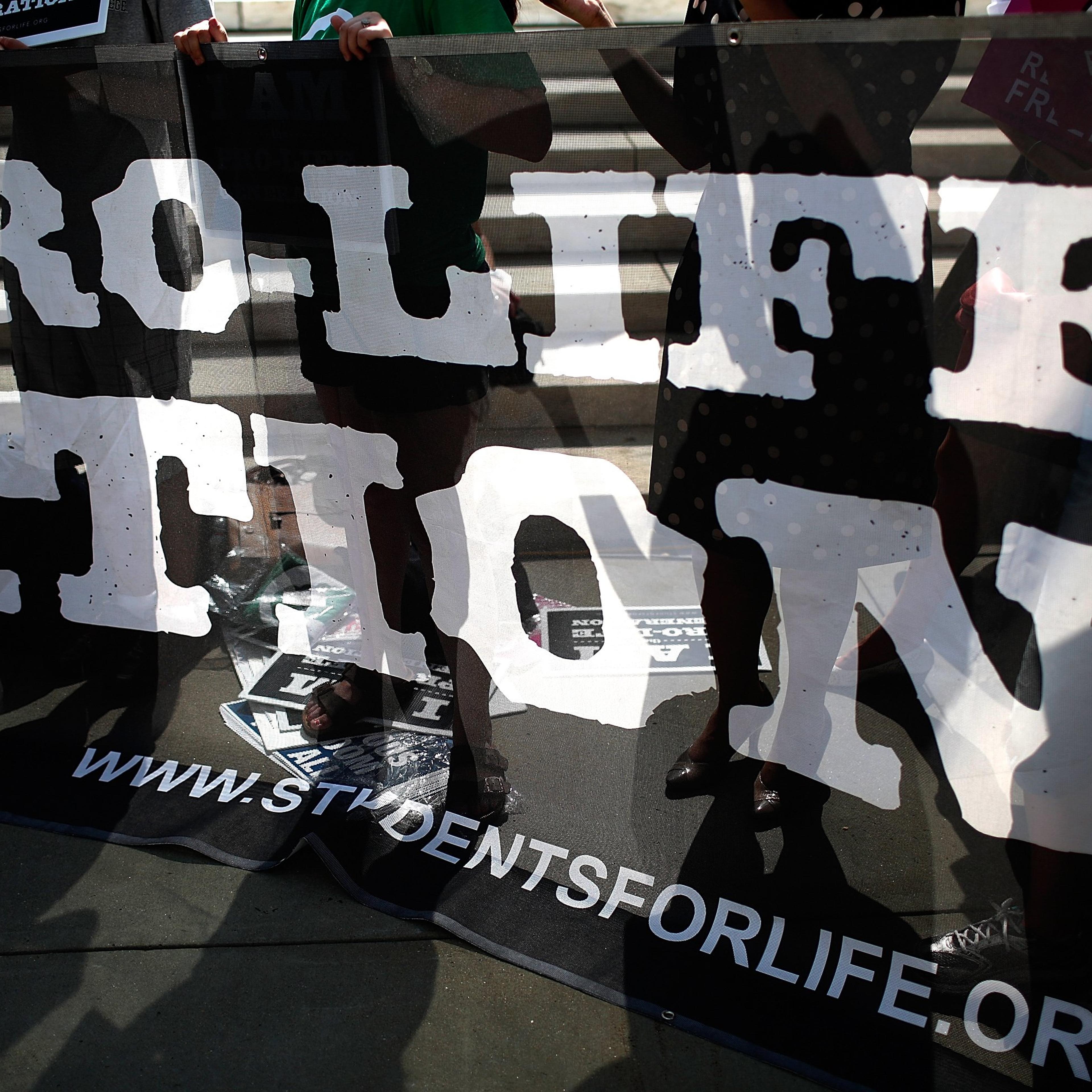 Pro-life activists gather outside the U.S. Supreme Court June 26, 2014 in Washington.
