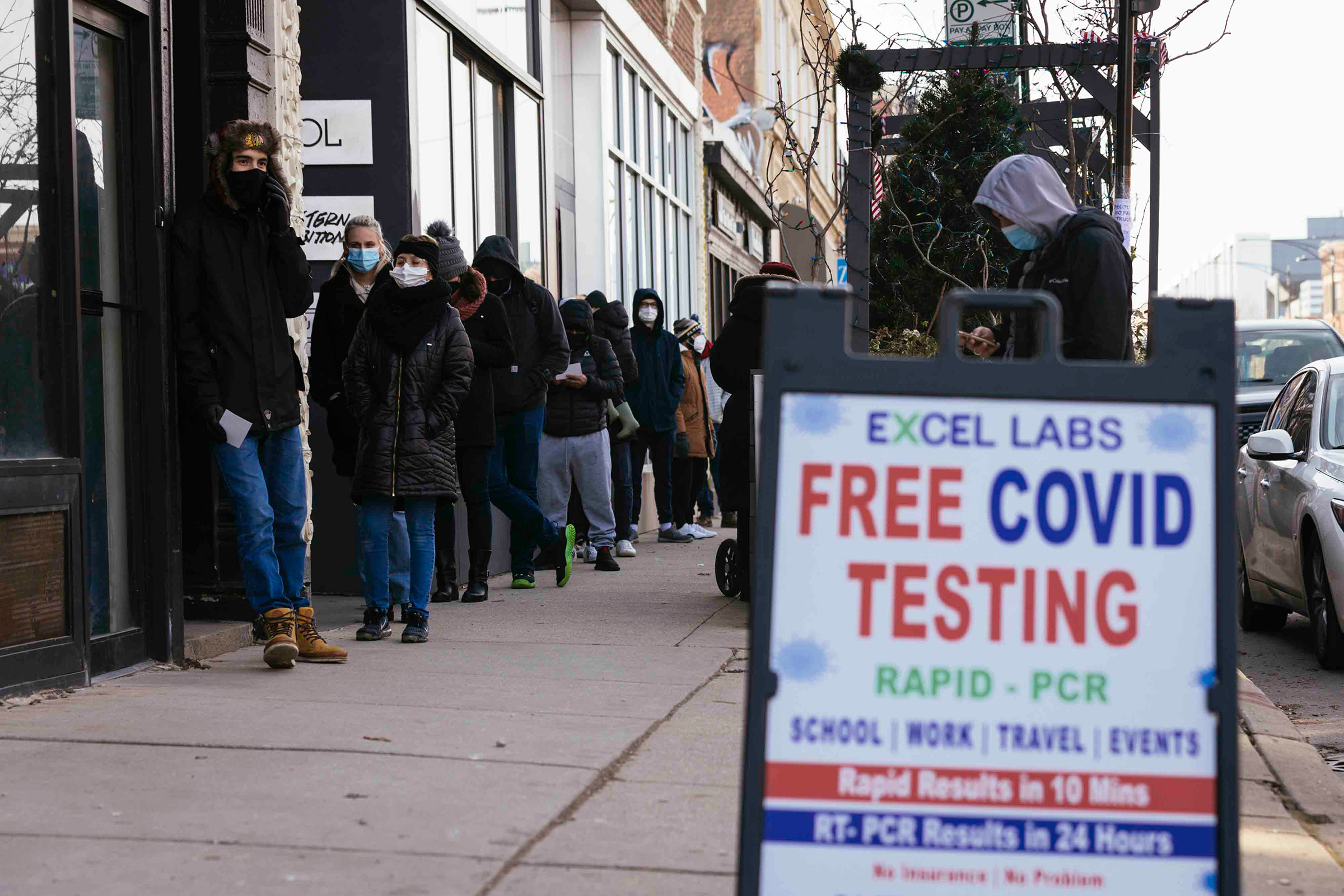People wait in line for free COVID-19 tests.
