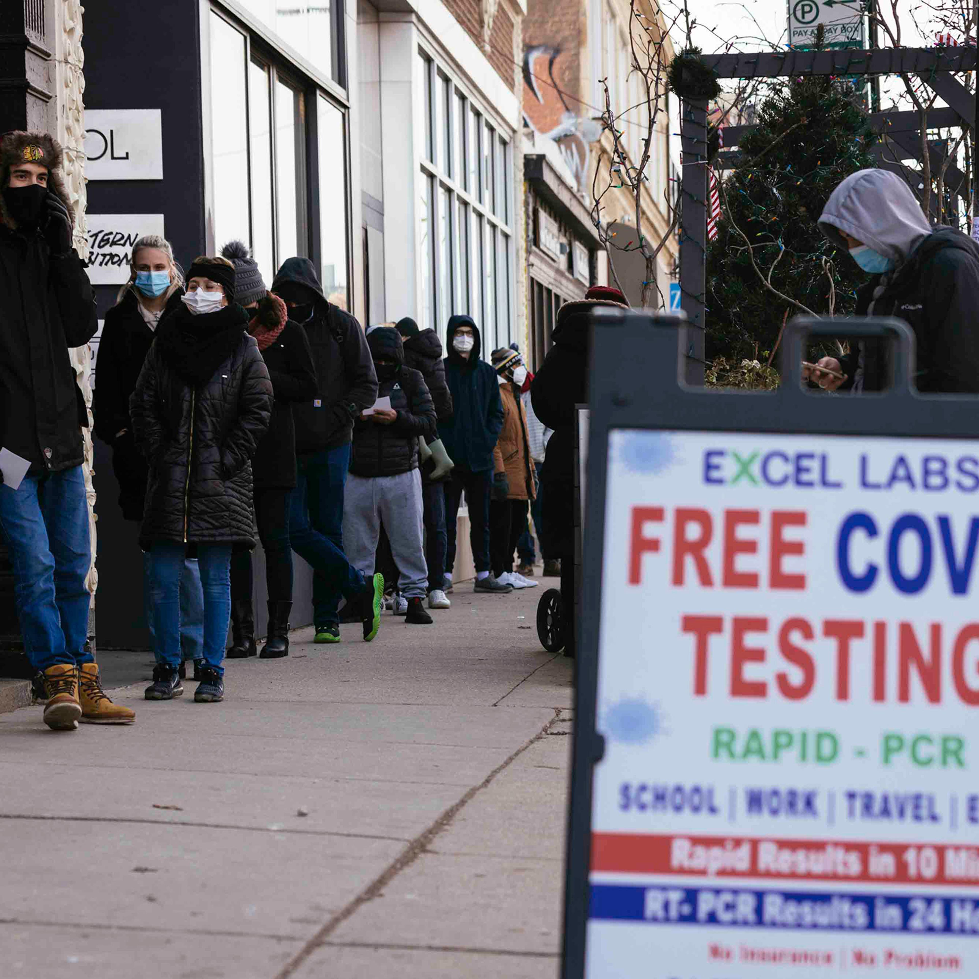 People wait in line for free COVID-19 tests.