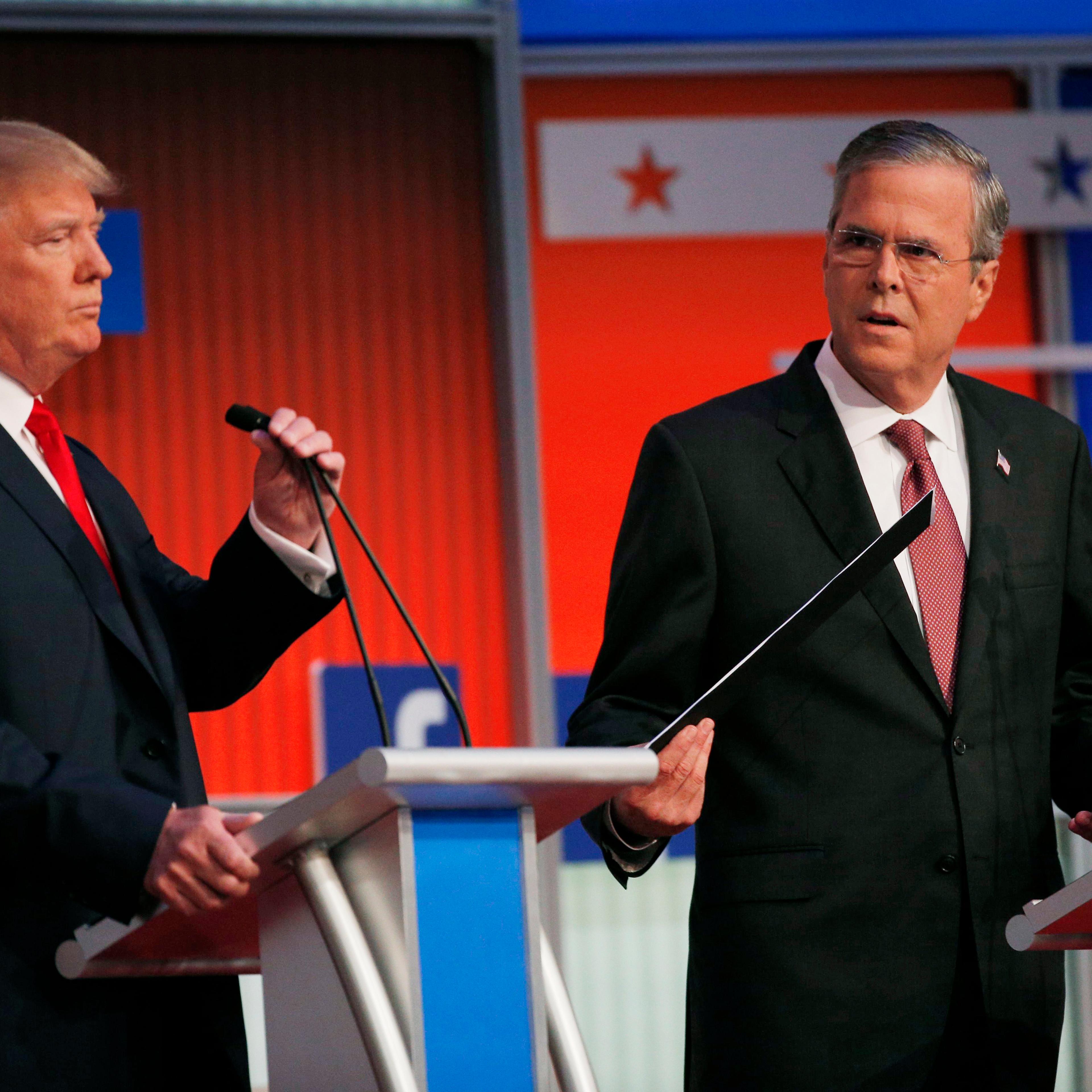 Republican 2016 presidential candidates Trump and Bush take their places at their podiums before the start of the first official Republican presidential candidates debate of the 2016 U.S. presidential campaign in Cleveland