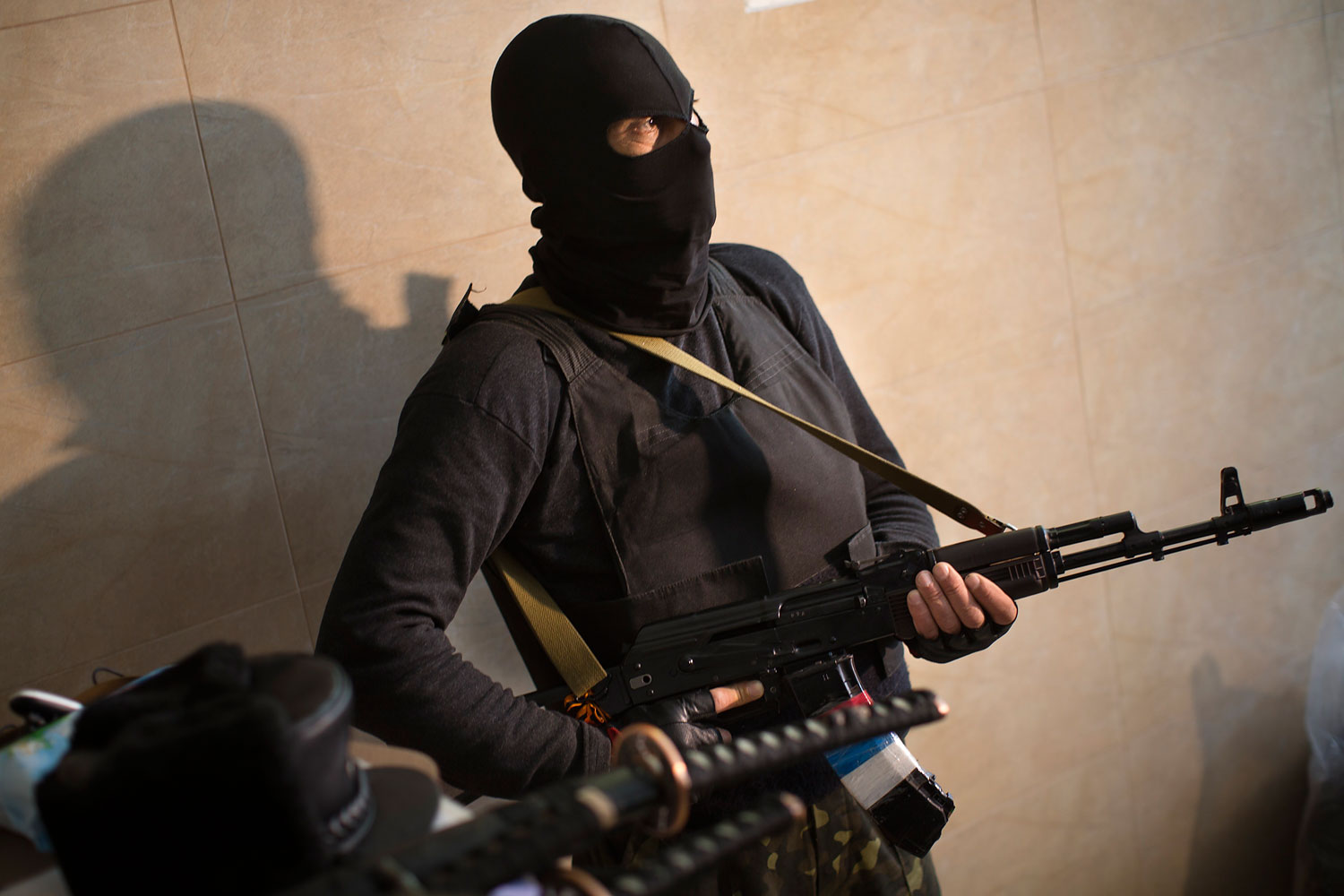 A pro-Russian gunman guards an entrance of the Regional Prosecutor's Office building they seized on Tuesday in Luhansk, one of the largest cities in eastern, Ukraine, April 30, 2014.