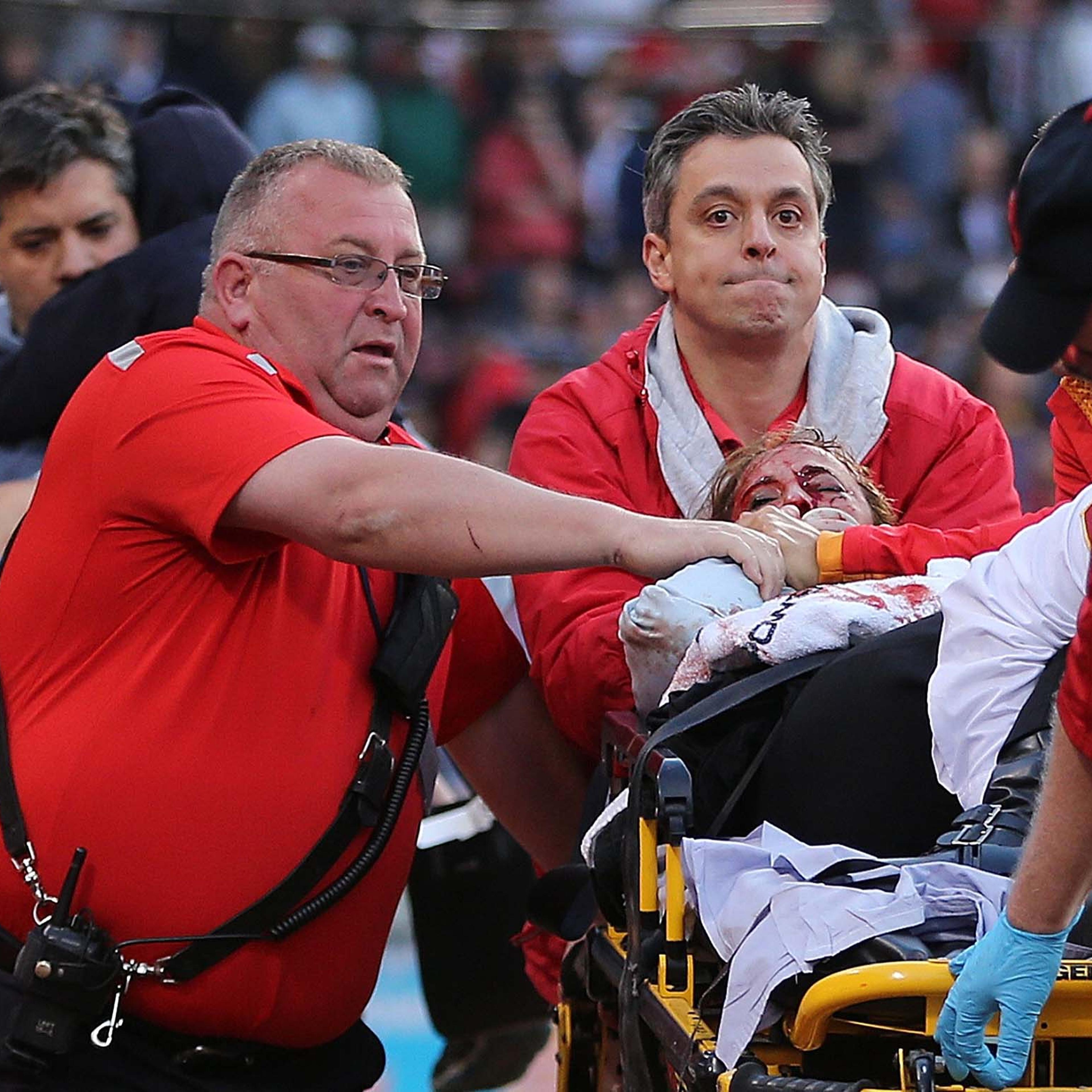 Medical staff attends to a woman who was hit by a broken bat during a game between the Boston Red Sox and the Oakland Athletics at Fenway Park on Friday, June 5, in Boston.
