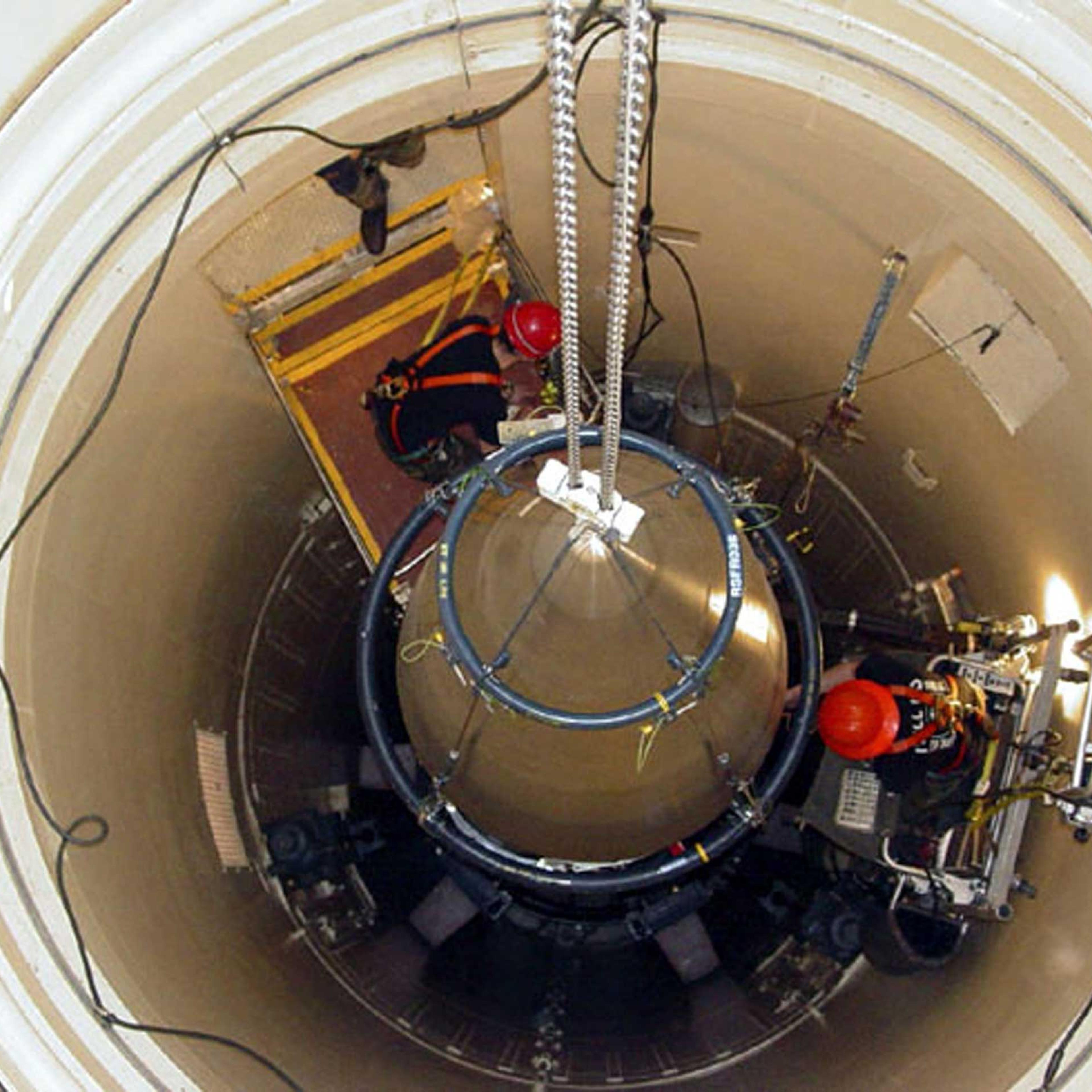 A US Air Force missile maintenance team removes the upper section of an intercontinental ballistic missile with a nuclear warhead in an undated USAF photo at Malmstrom Air Force Base, Montana.