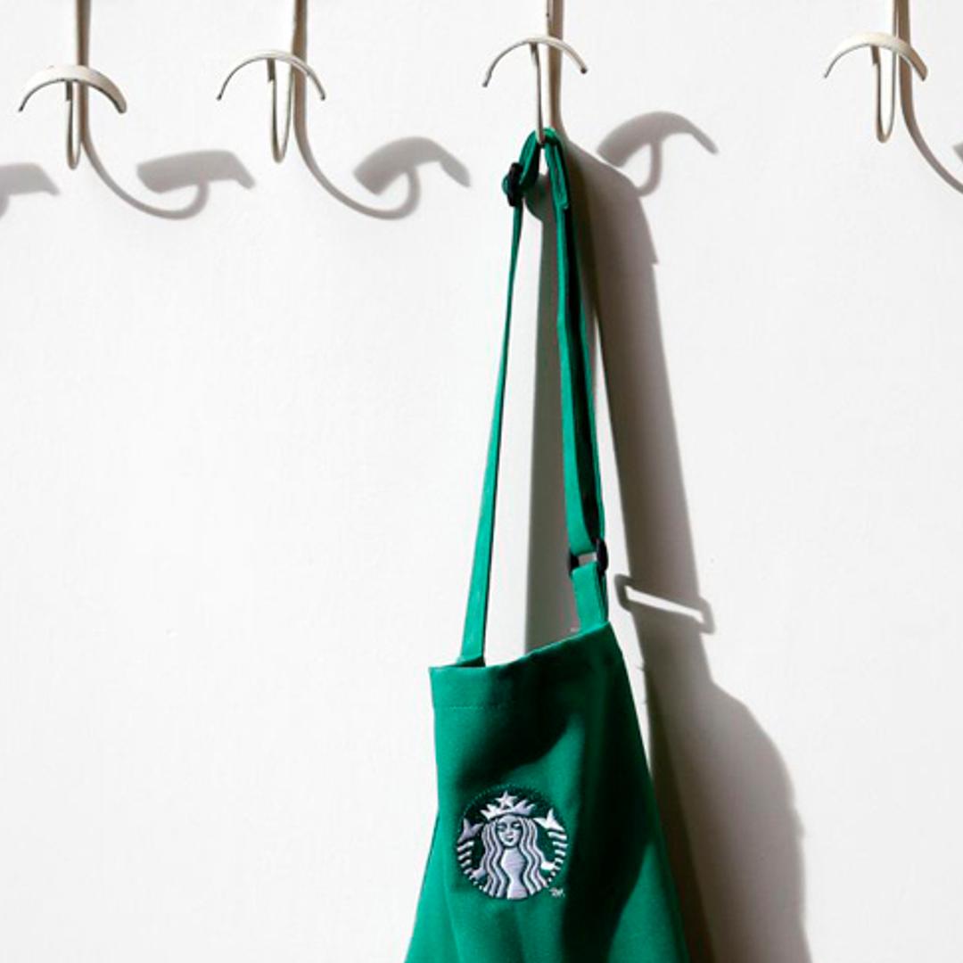 A barrista's apron hangs on a peg in Starbucks' Mayfair Vigo Street branch in central London