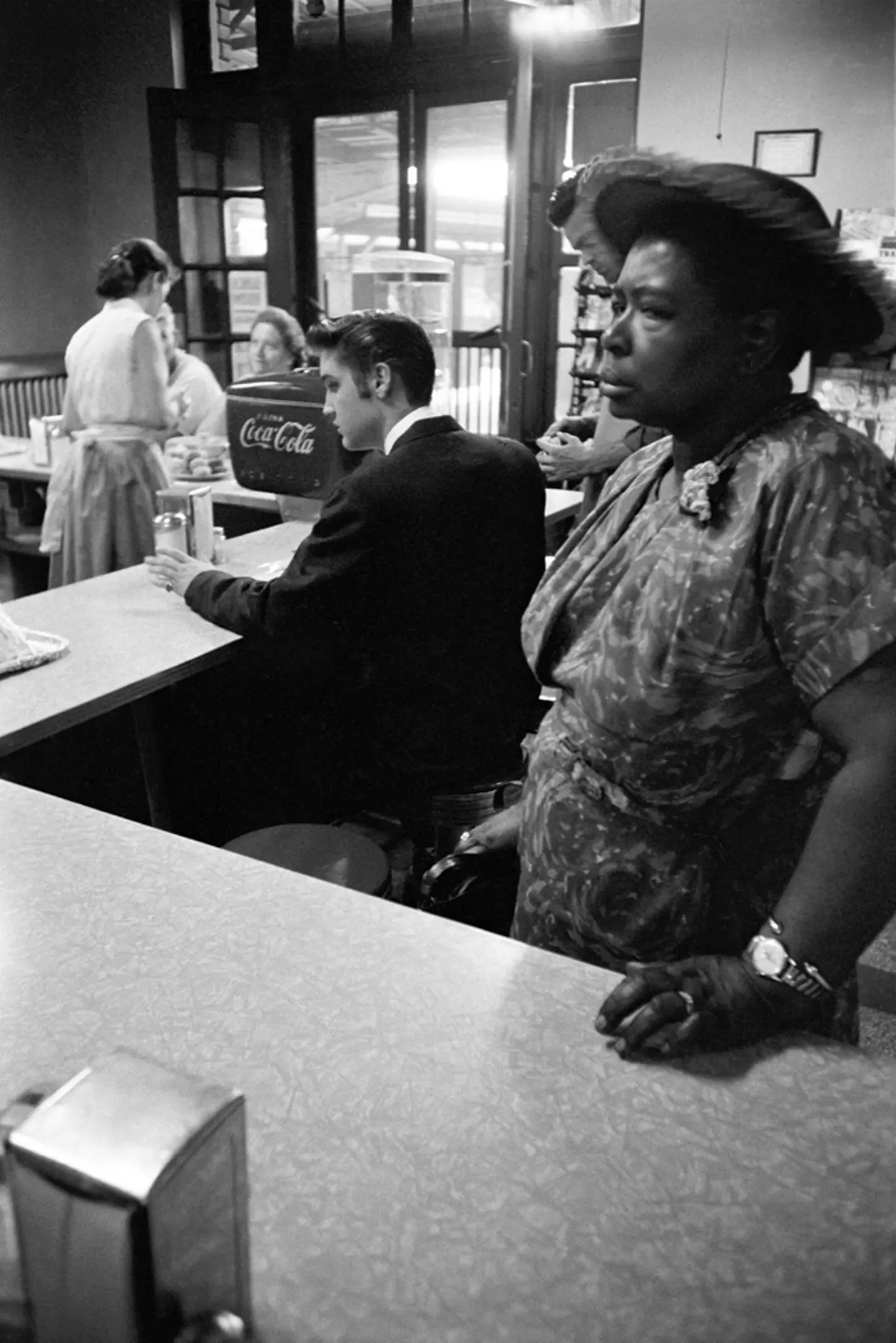 July 4, 1956. Chattanooga railroad station. This is a segregated lunch counter. This woman got suspicious of me, ordered a tuna fish sandwich and walked in front of my lens. She then moved when she picked up her sandwich to go to the waiting room to eat.