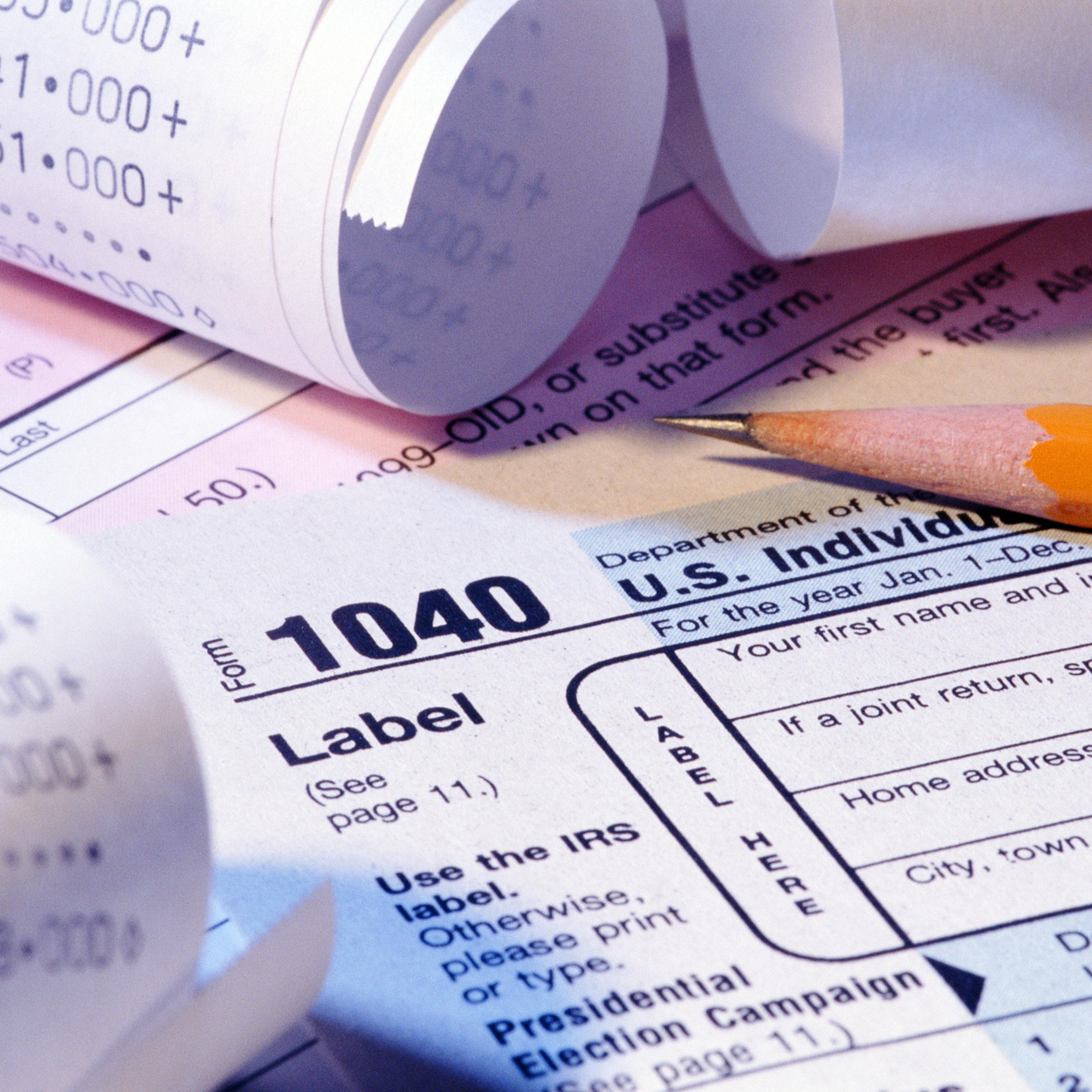 Tax forms, pencil and receipts, close-up