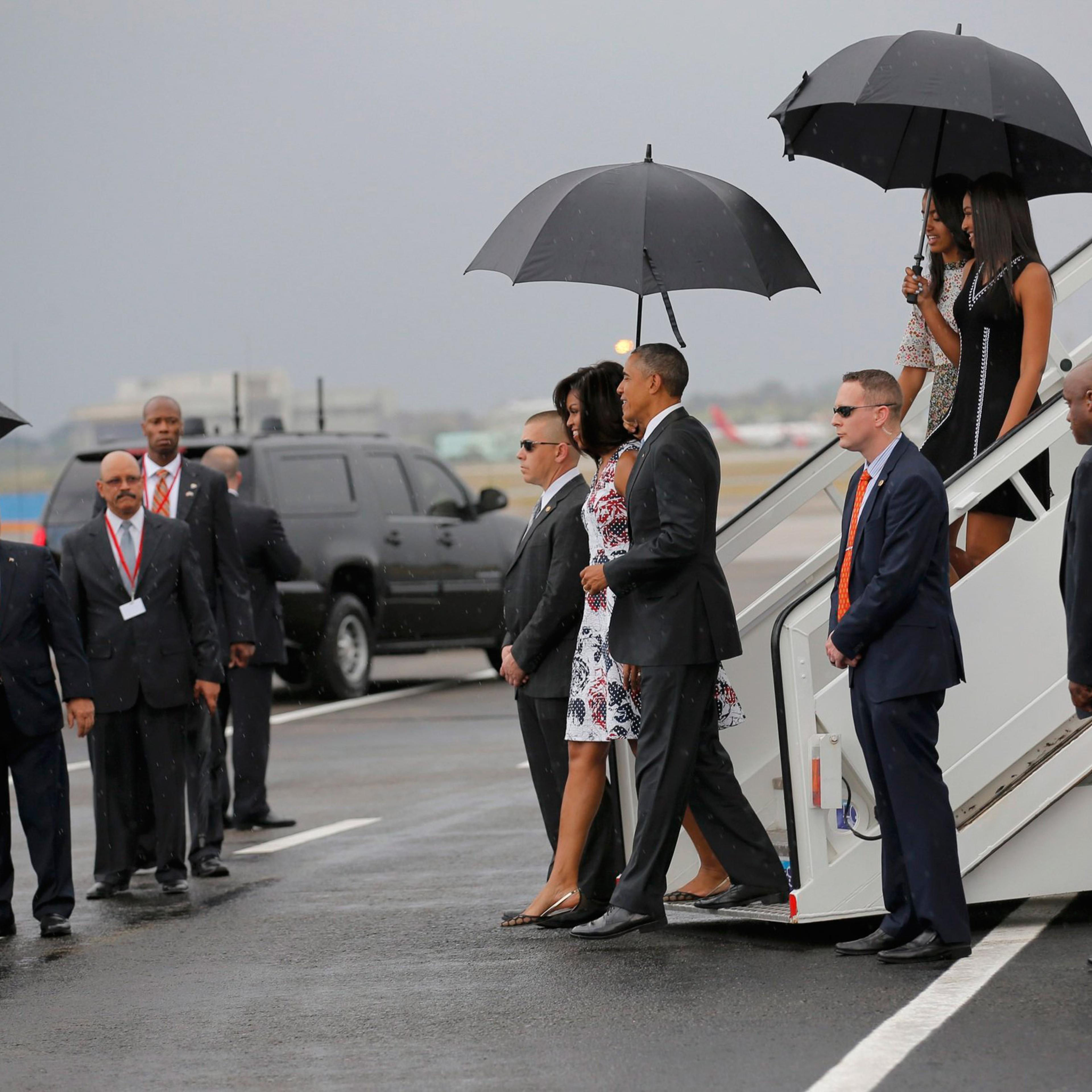 U.S. President Barack Obama and his wife Michelle approach Cuba's foreign minister Bruno Rodriguez (L) as they arrive at Havana's international airport for a three-day trip, in Havana March 20, 2016. REUTERS/Carlos Barria
