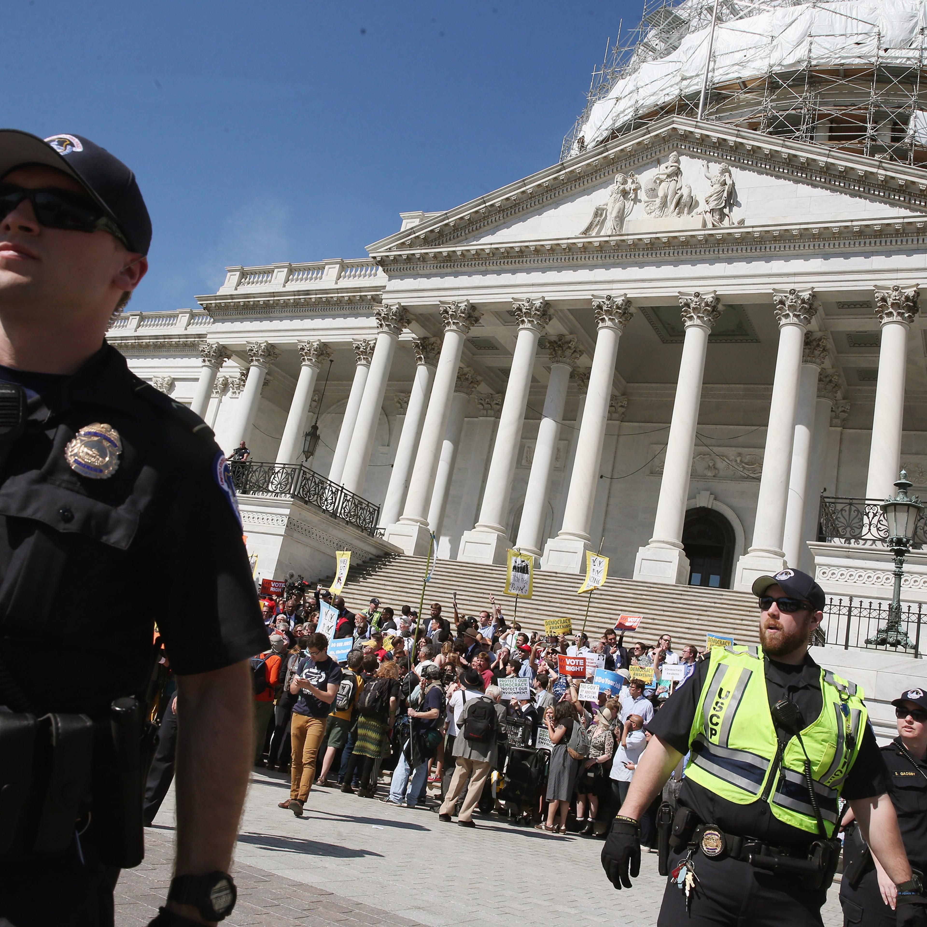 WASHINGTON, DC - APRIL 18: US Capitol Police give protesters a warning to move away from the front of the Capitol or get arrested, April 18, 2016 in Washington, DC. Protest groups Public Citizen and People for the American Way have been protesting the in