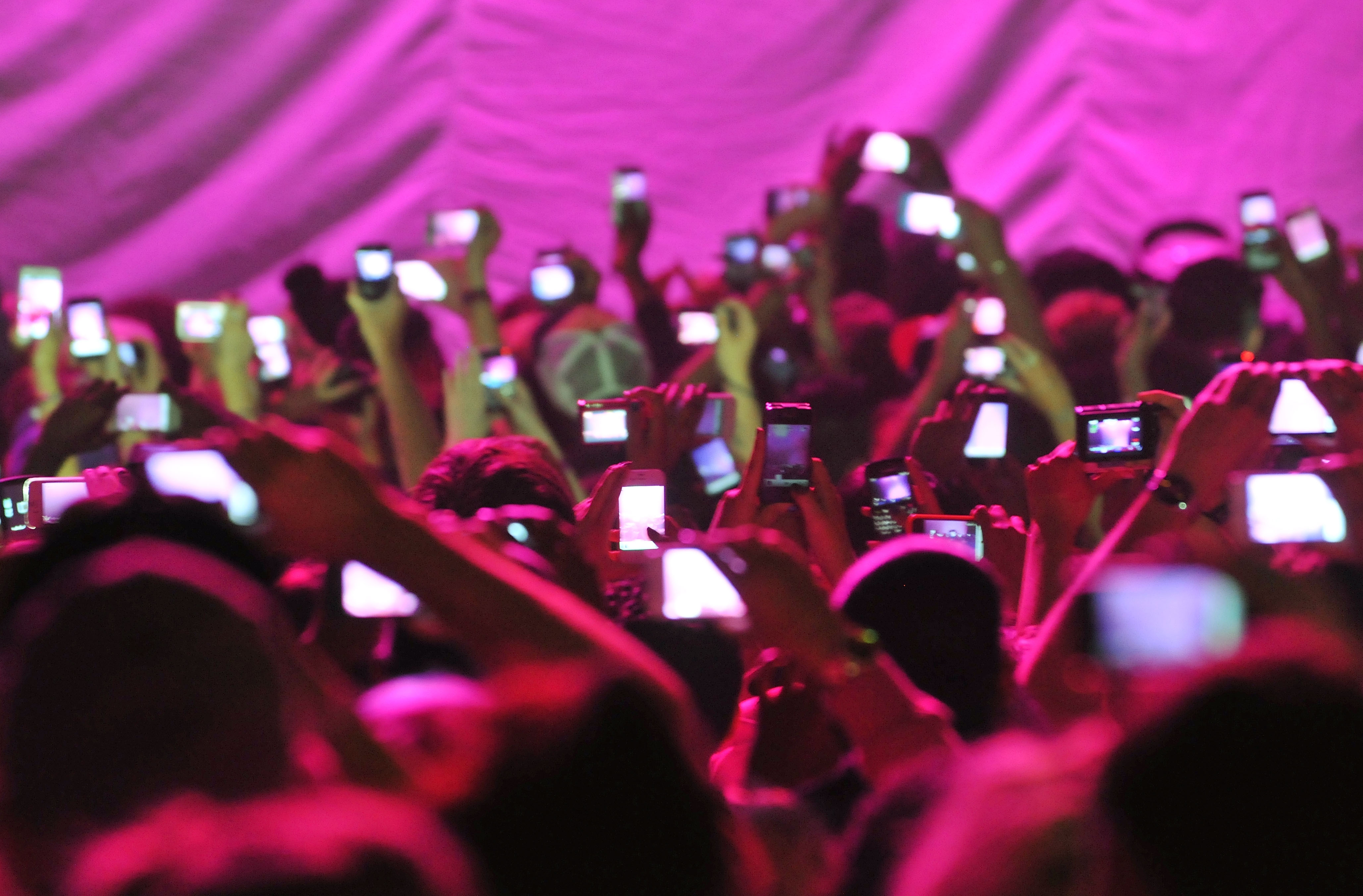 Members of the audience hold up cameras and mobile telephones as American rapper and R&B singer Nicki Minaj takes to the stage stage during her 'Pink Friday' tour at HMV Hammersmith Apollo on June 24, 2012 in London, United Kingdom.