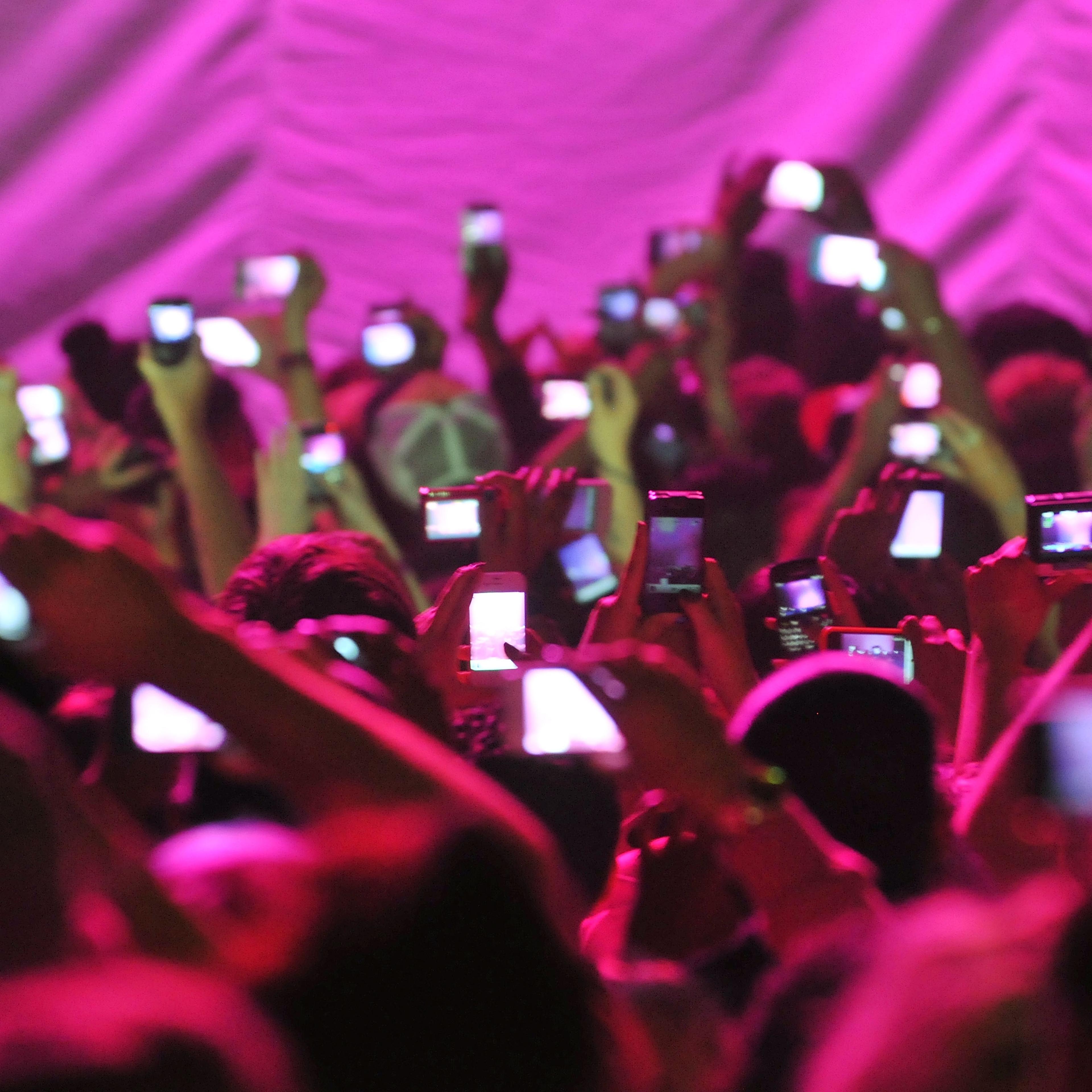 Members of the audience hold up cameras and mobile telephones as American rapper and R&B singer Nicki Minaj takes to the stage stage during her 'Pink Friday' tour at HMV Hammersmith Apollo on June 24, 2012 in London, United Kingdom.