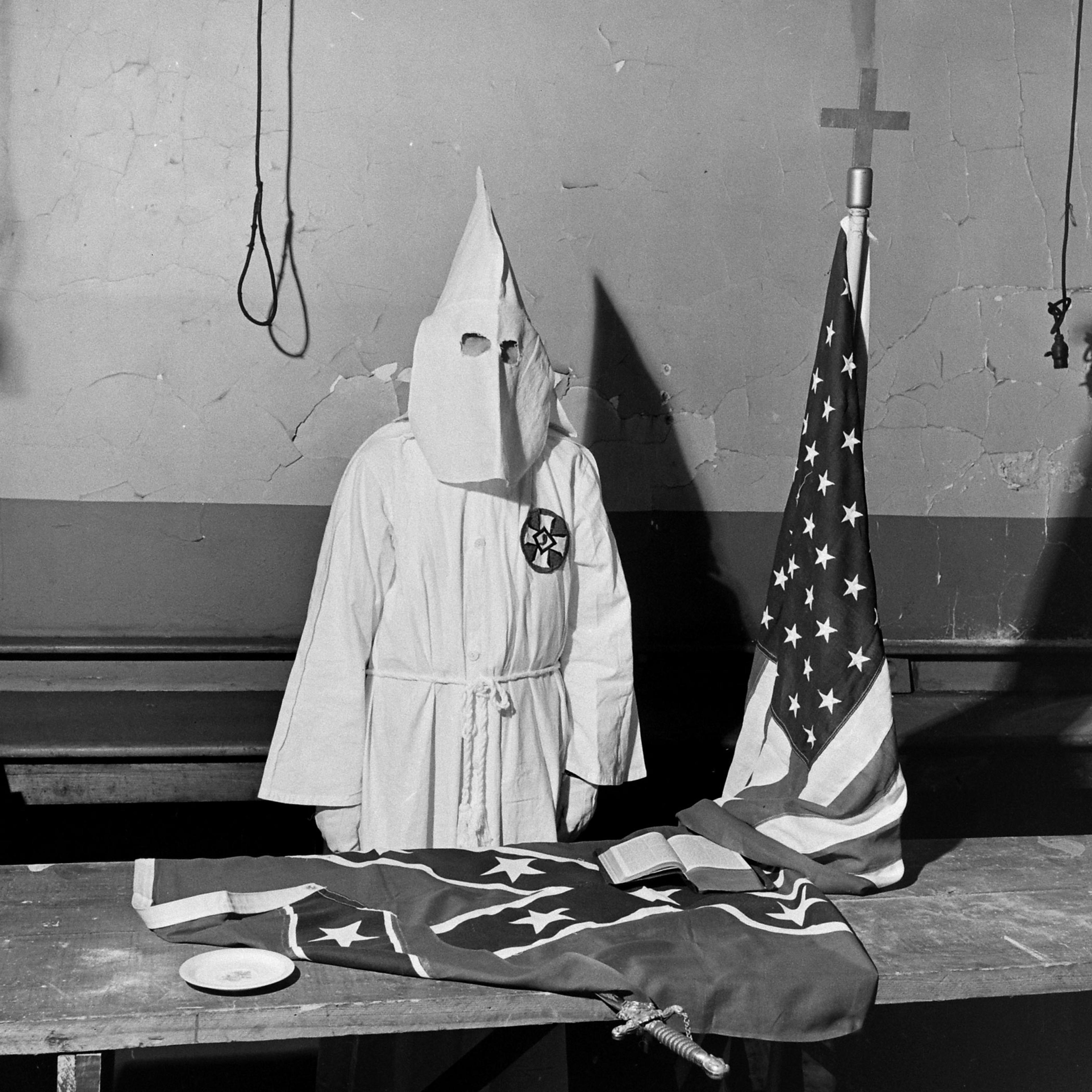 A Ku Klux Klan member demonstrates ritualistic aspects of a KKK meeting, Georgia, May 1946.
