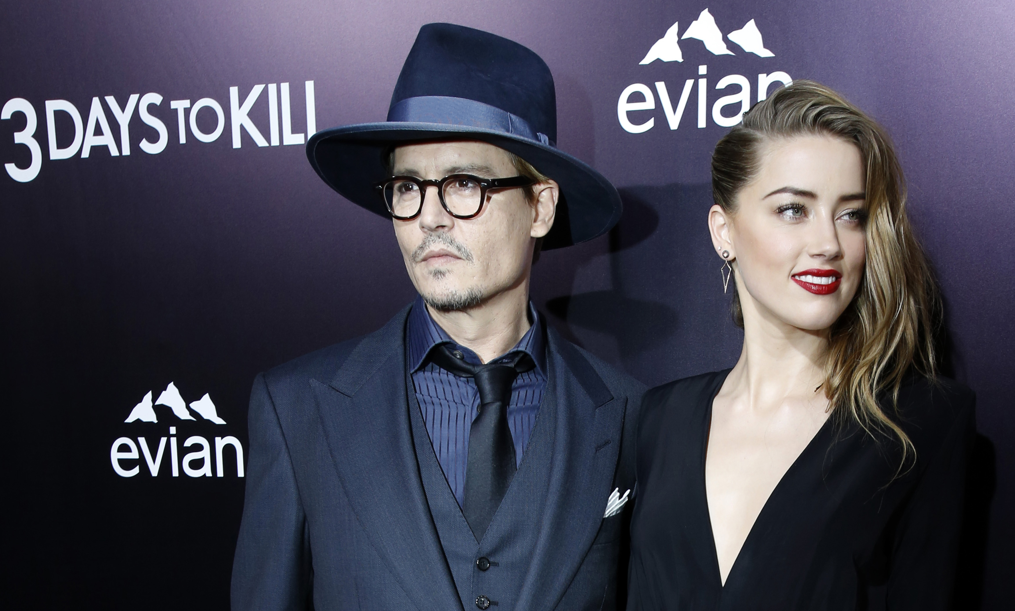 Cast member Amber Heard and her fiance, actor Johnny Depp pose at the premiere of "3 Days to Kill" in Los Angeles
