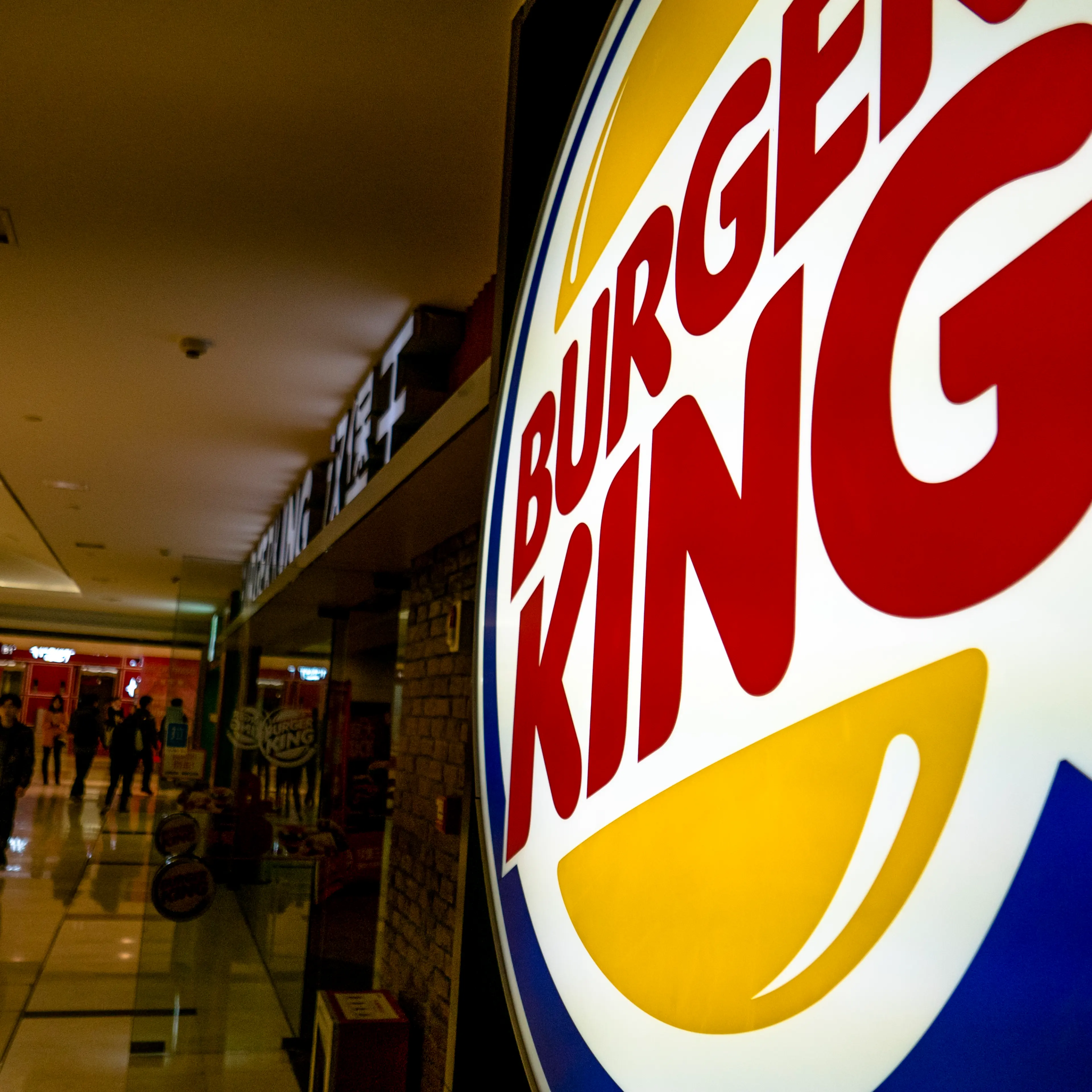 Lightbox logo of Burger King in a shopping mall. While