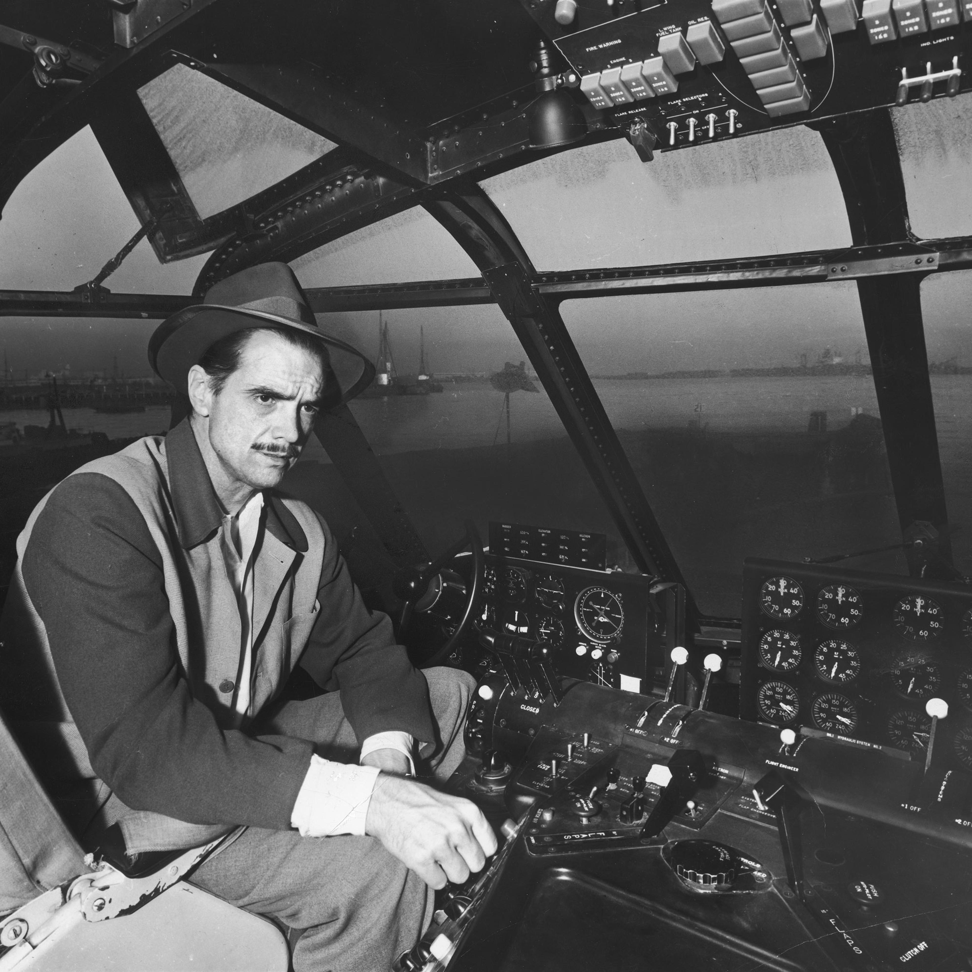 Howard Hughes' at the controls of his H-4 Hercules troop transport plane, the "Spruce Goose," November 1947.