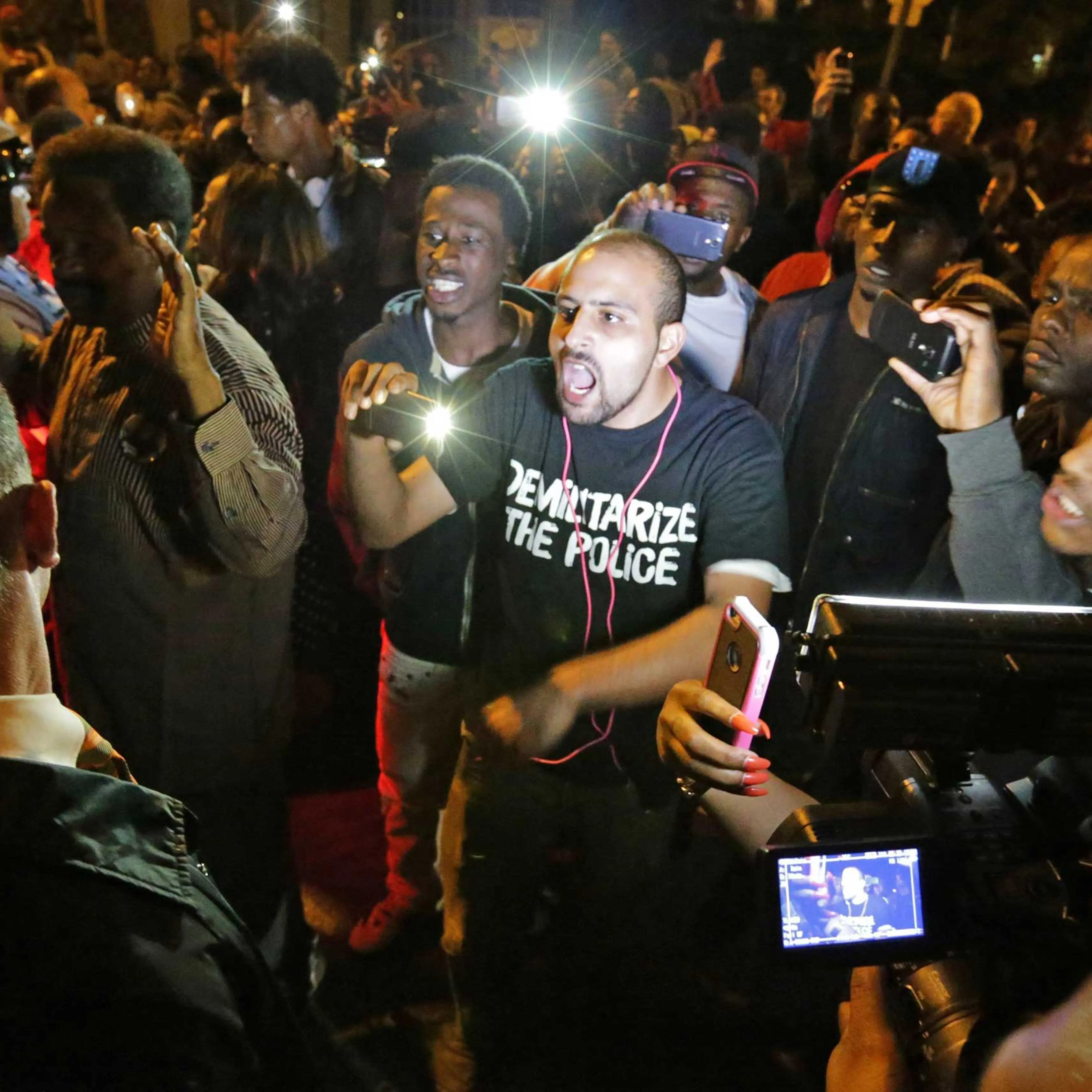 Crowds confront police near the scene in in south St. Louis where a man was fatally shot by an off-duty St. Louis police officer on Oct. 8, 2014. St. Louis.
