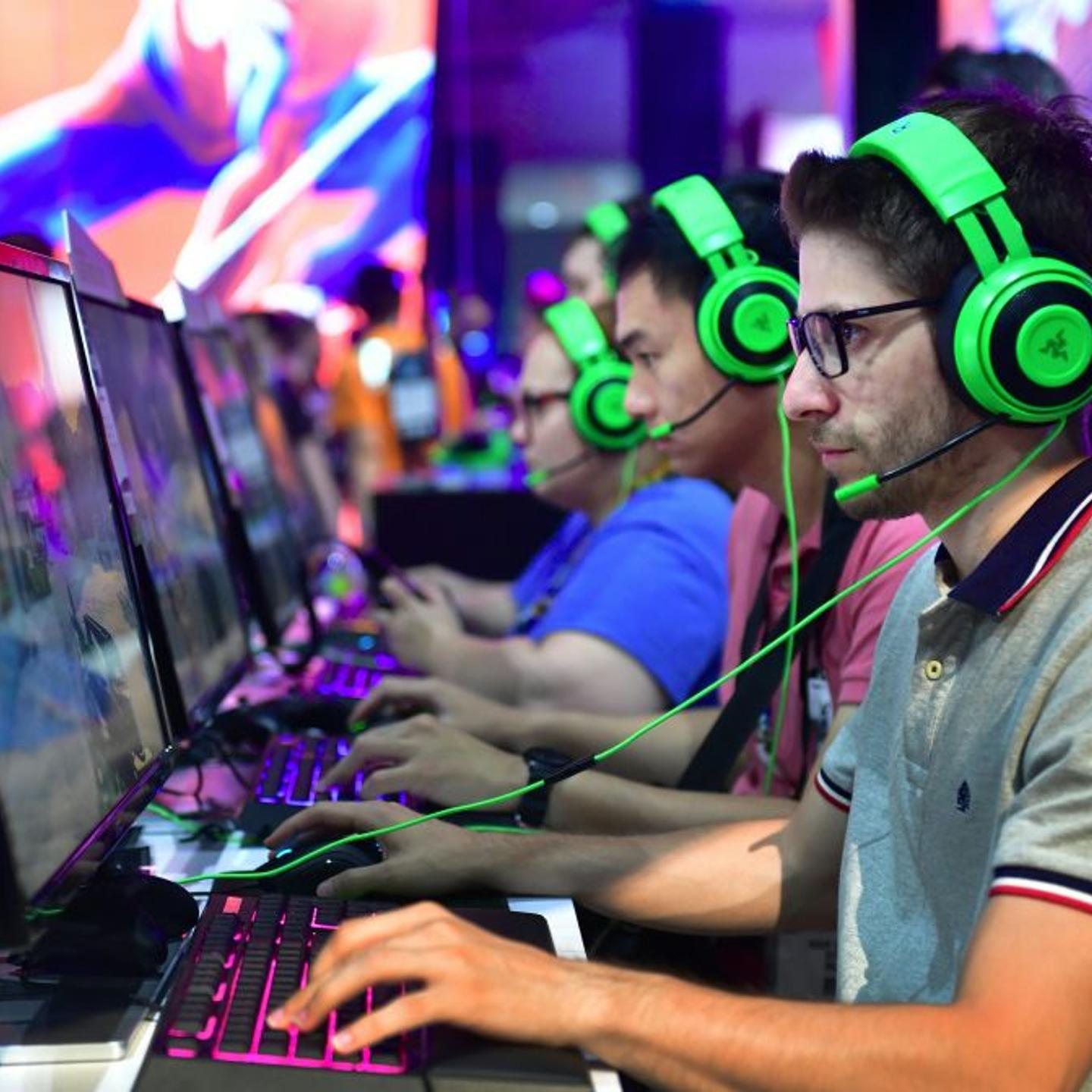 Video game workers wear headsets at E3 in Los Angeles