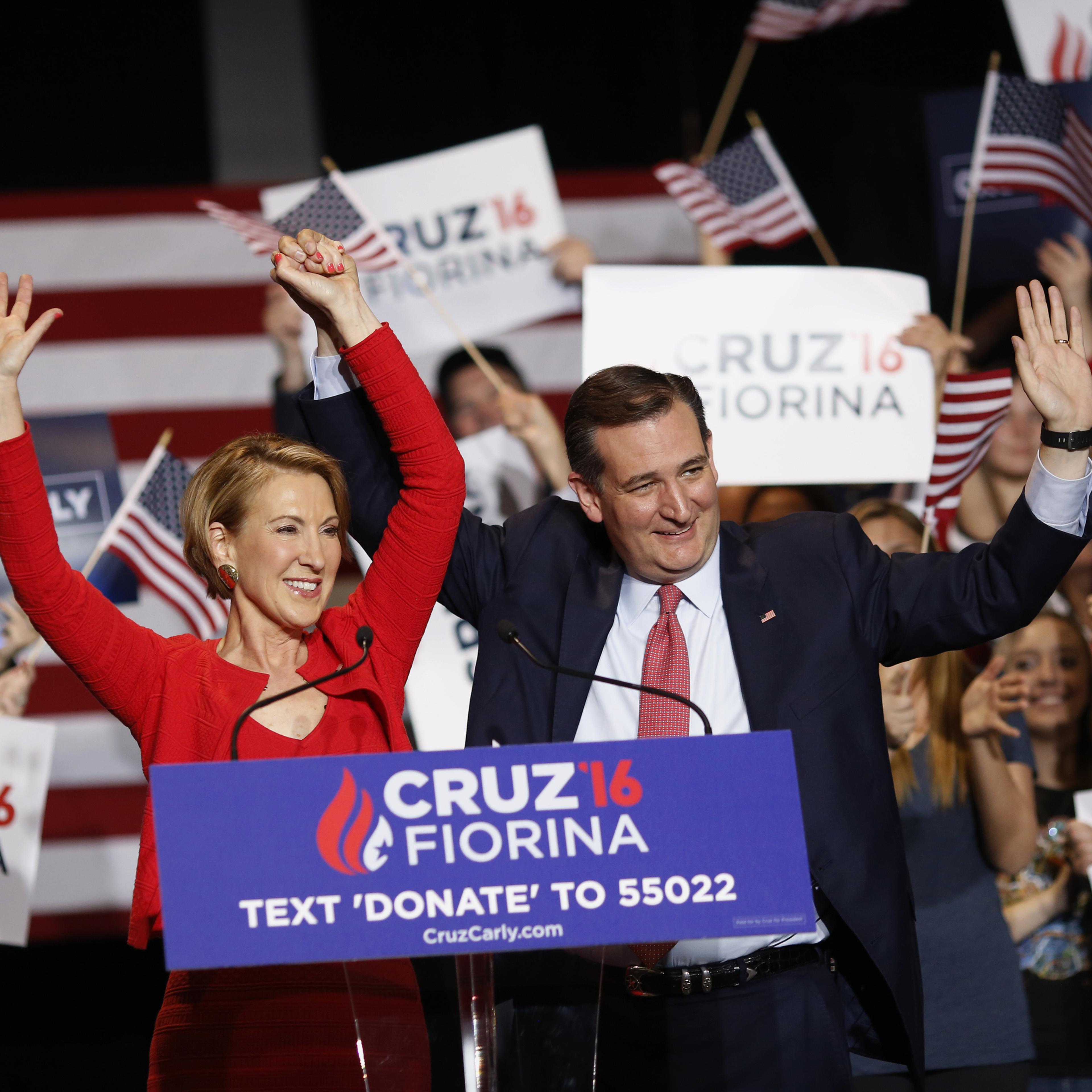 Carly Fiorina, former chairman and chief executive officer of Hewlett-Packard Co., left, and Senator Ted Cruz, a Republican from Texas and 2016 presidential candidate, waves to attendees during a campaign rally in Indianapolis on April 27, 2016.
