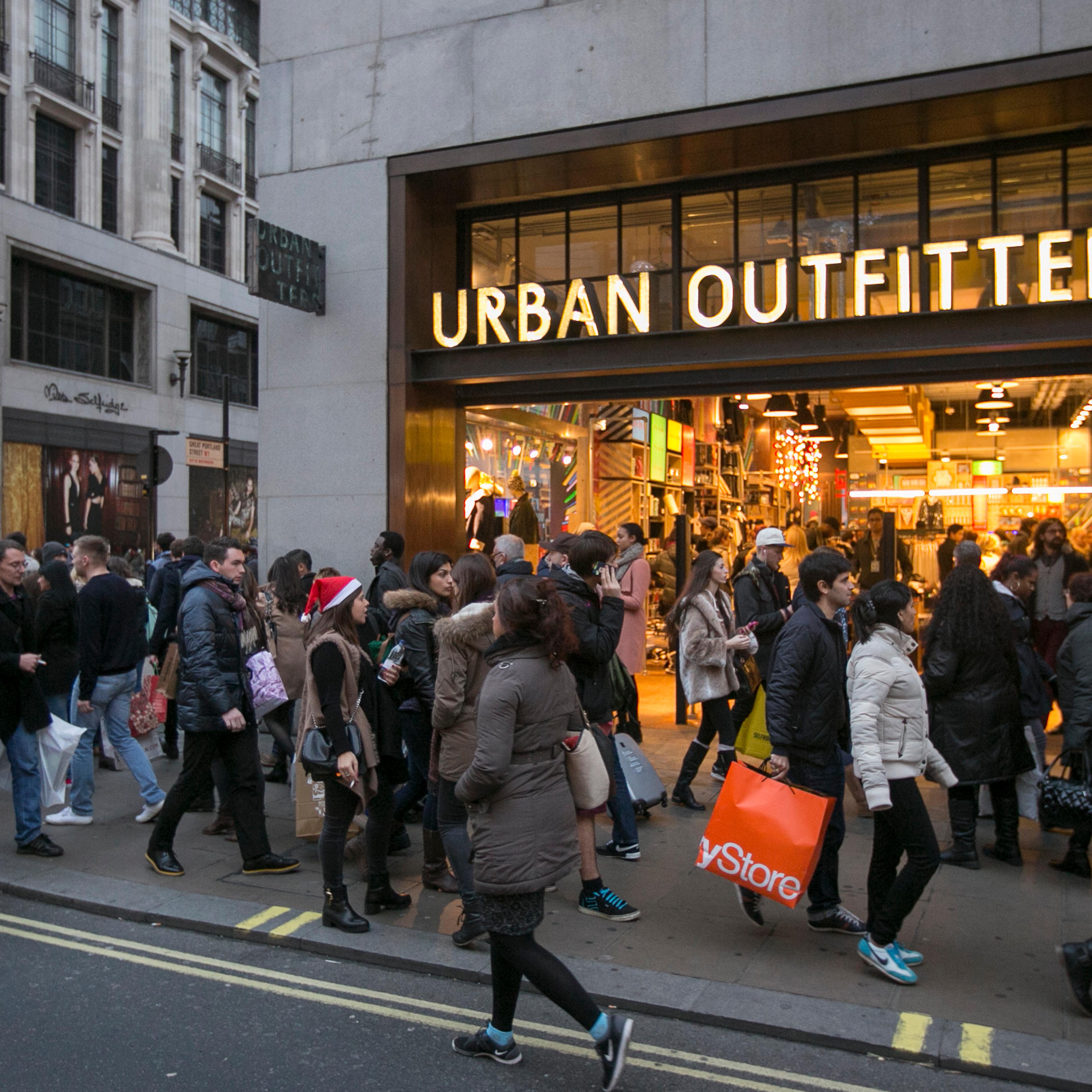 Shoppers walk outside Urban Outfitters on Dec. 14, 2013 in London.