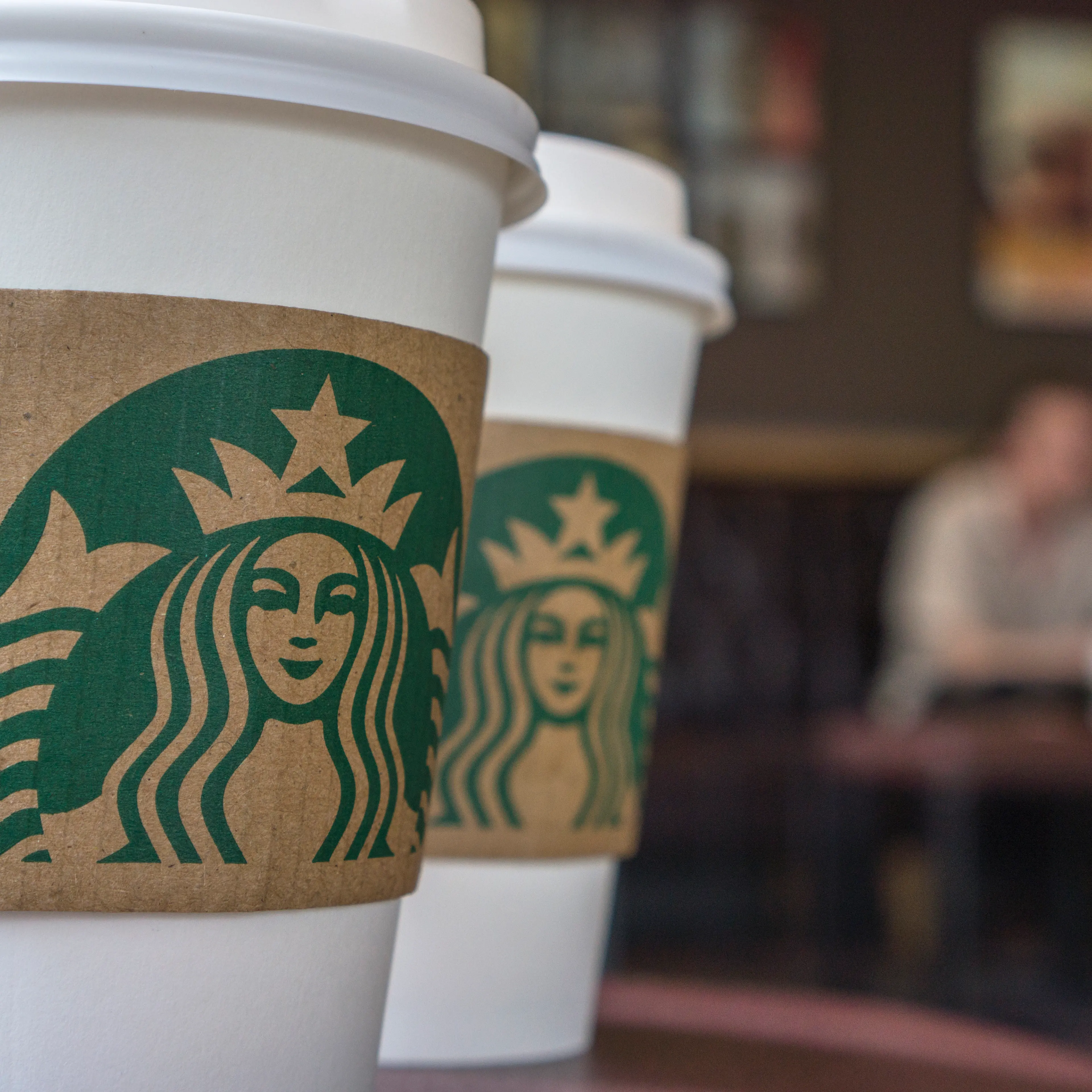 Coffee cups on the table in a Starbucks shop. Last Thursday
