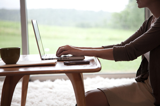 woman-typing-computer-home