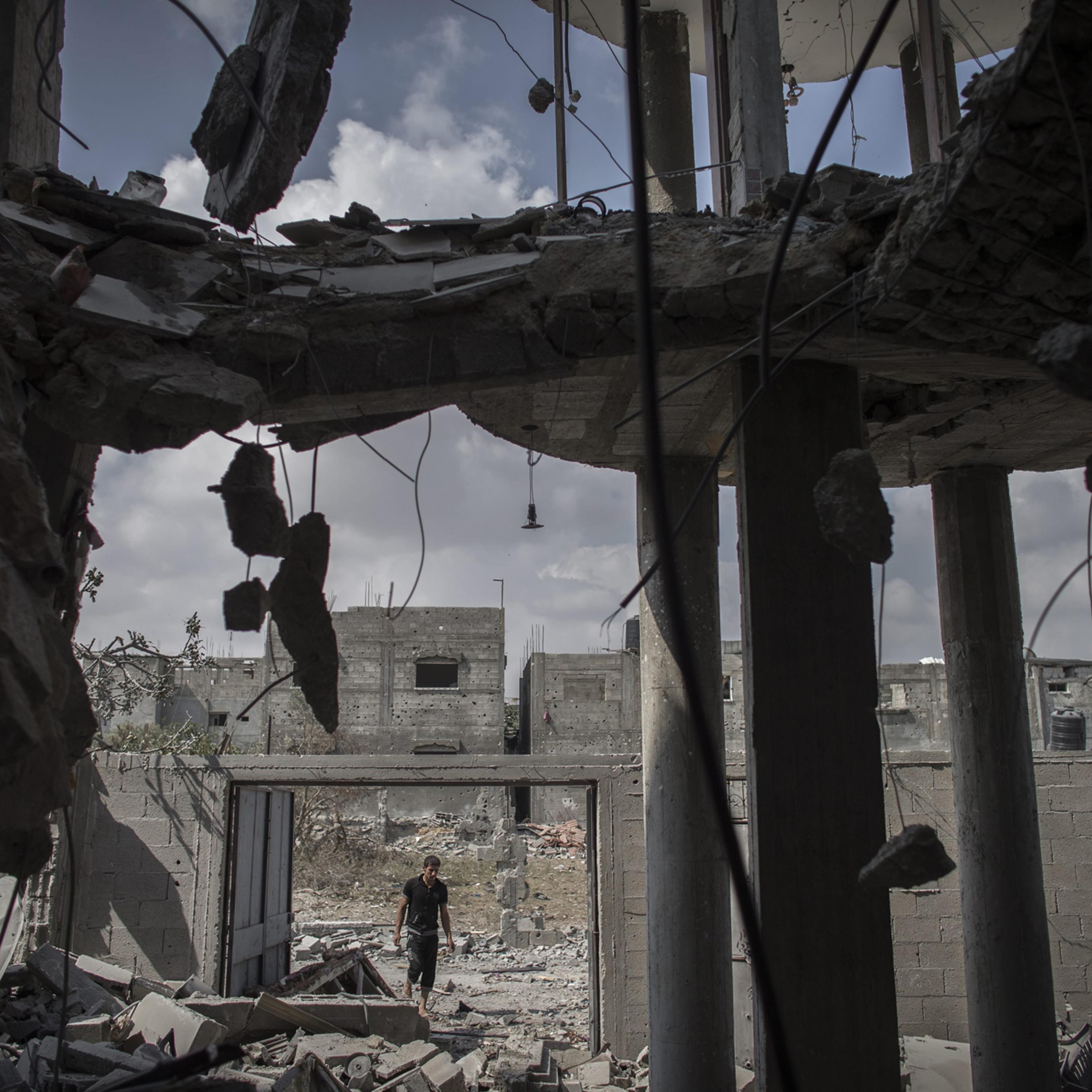 A Palestinian man enters his destroyed home in Beit Hanoun, northern Gaza Strip, August 5, 2014.