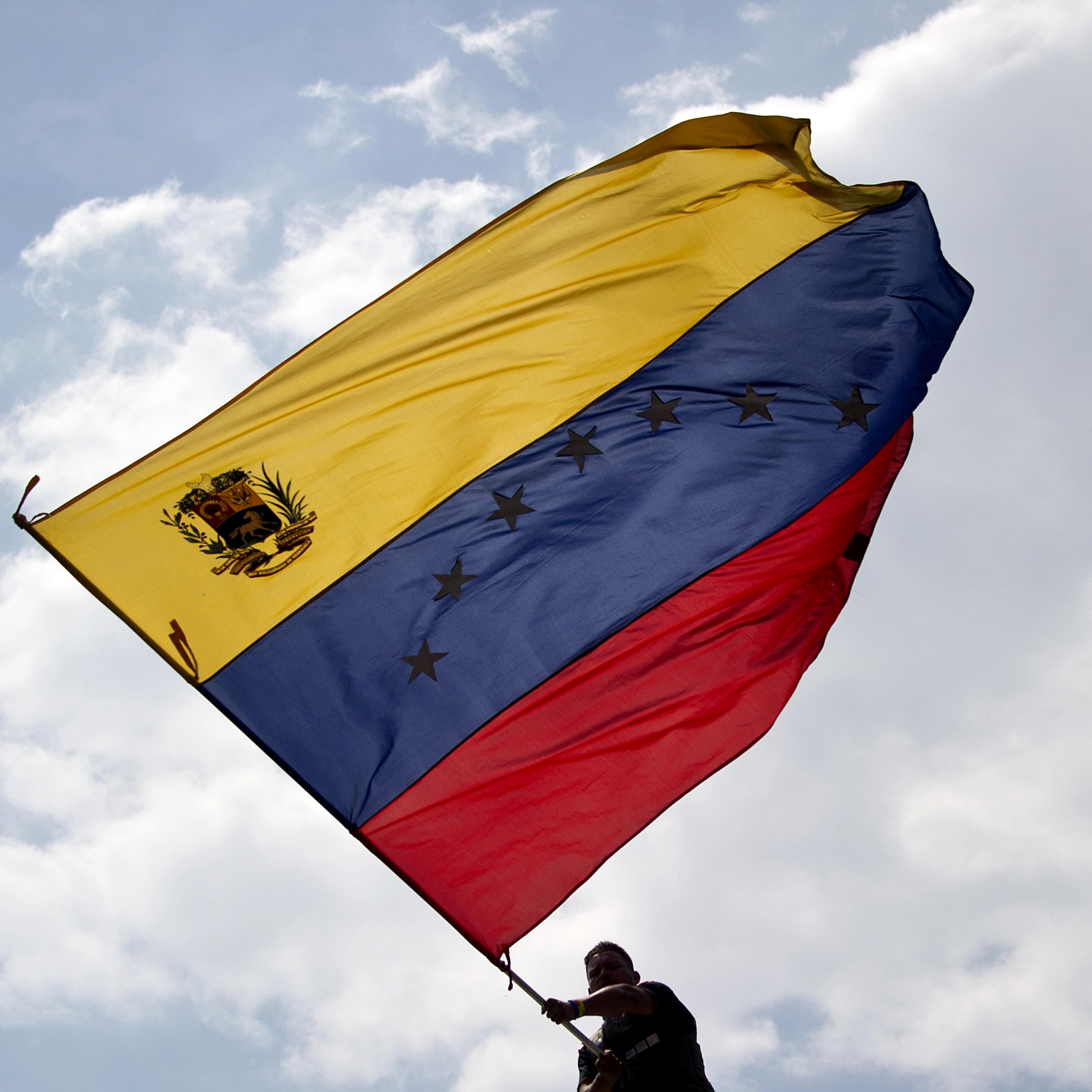 A man waves a Venezuelan flag during a protest against the government of President Nicolas Maduro in San Cristobal, Venezuela, on Feb. 22, 2014.