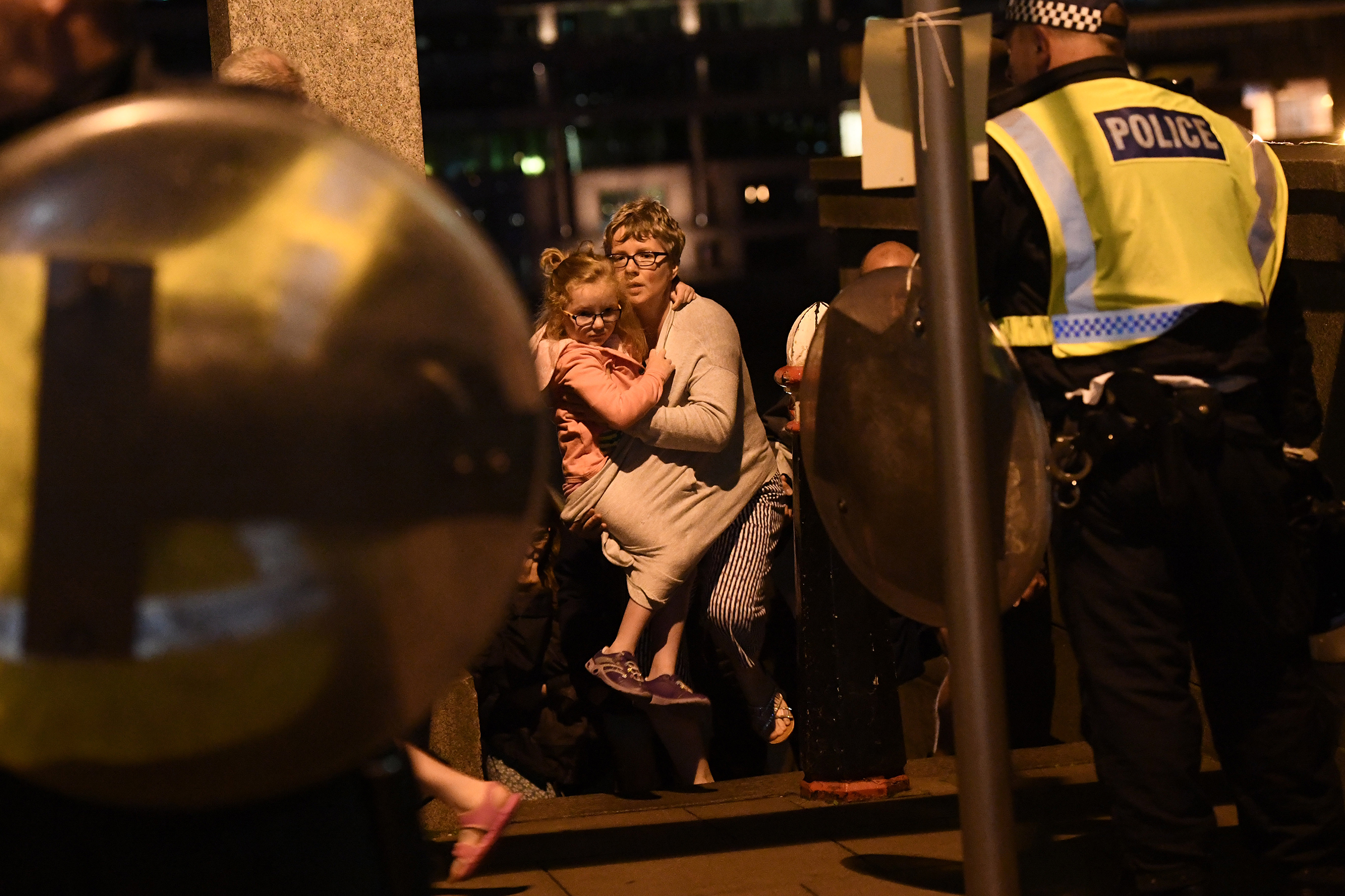 A woman and young girl are lead to safety on Southwark Bridge, away from London Bridge, after an attack on June 4, 2017.