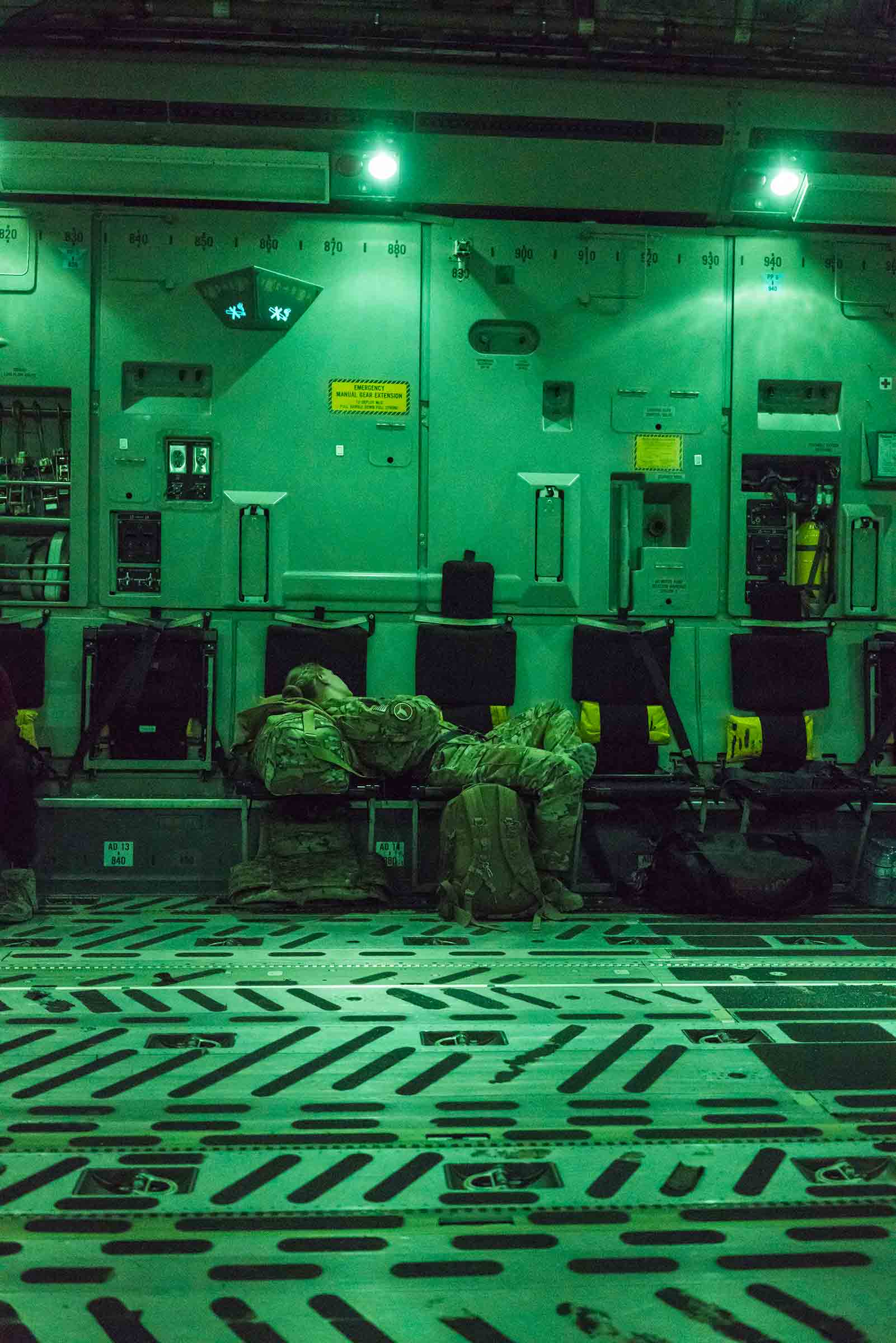 A U.S. soldier rests on a flight to Kabul in August 2018. The war in Afghanistan is nearly two decades old.