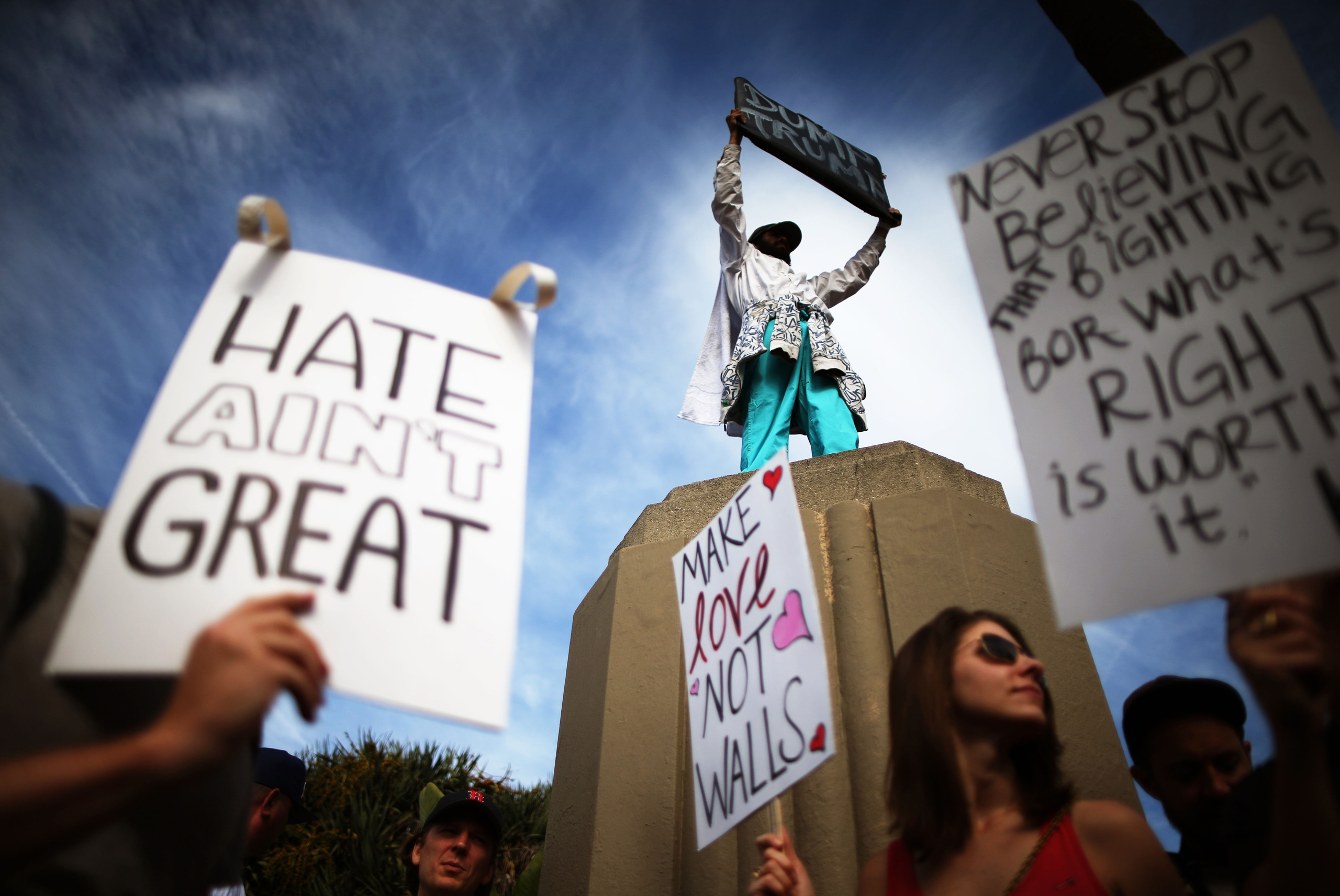 Protesters hold up signs during a march and rally against the election of Republican Donald Trump as President of the United States in Los Angeles, on Nov. 12, 2016.