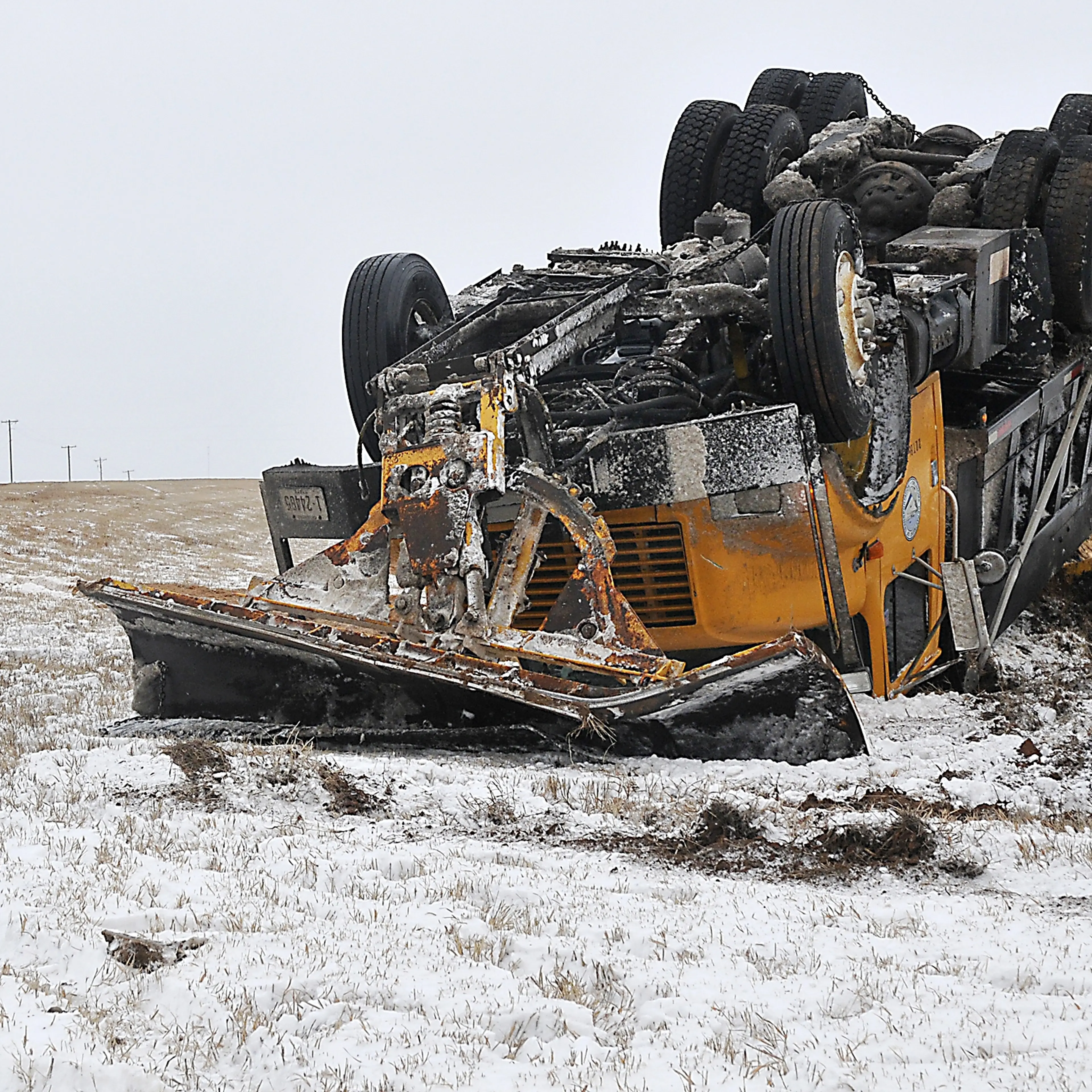 An Oklahoma Department of Transportation sand truck rest on it's top in the median of US 412 west of Enid, Okla. Sunday, after it was involved in an accident with another vehicle on Feb. 22, 2015