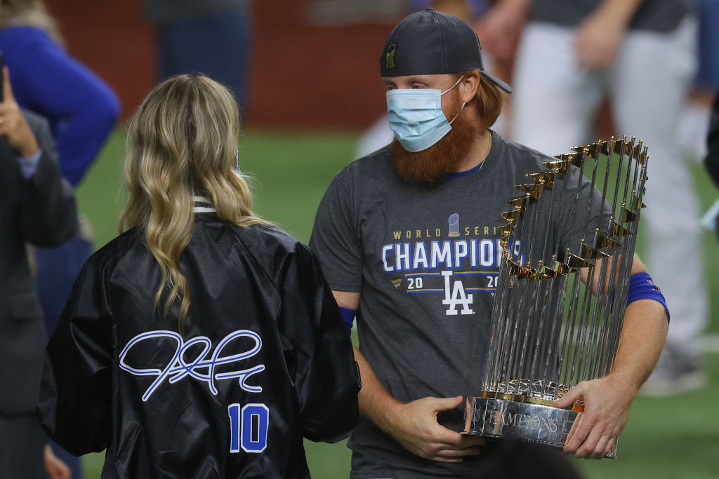 Justin Turner #10 of the Los Angeles Dodgers and his wife Kourtney Pogue, hold the Commissioners Trophy after the teams 3-1 victory against the Tampa Bay Rays in Game Six to win the 2020 MLB World Series at Globe Life Field on October 27, 2020 in Arlingt