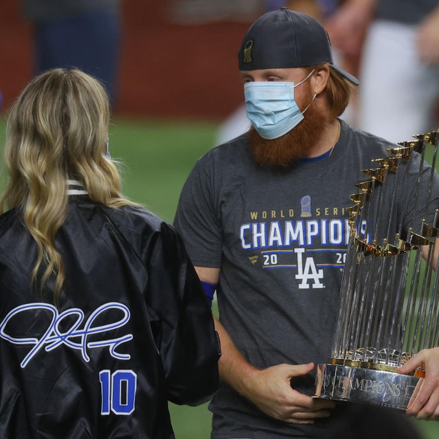 Justin Turner #10 of the Los Angeles Dodgers and his wife Kourtney Pogue, hold the Commissioners Trophy after the teams 3-1 victory against the Tampa Bay Rays in Game Six to win the 2020 MLB World Series at Globe Life Field on October 27, 2020 in Arlingt