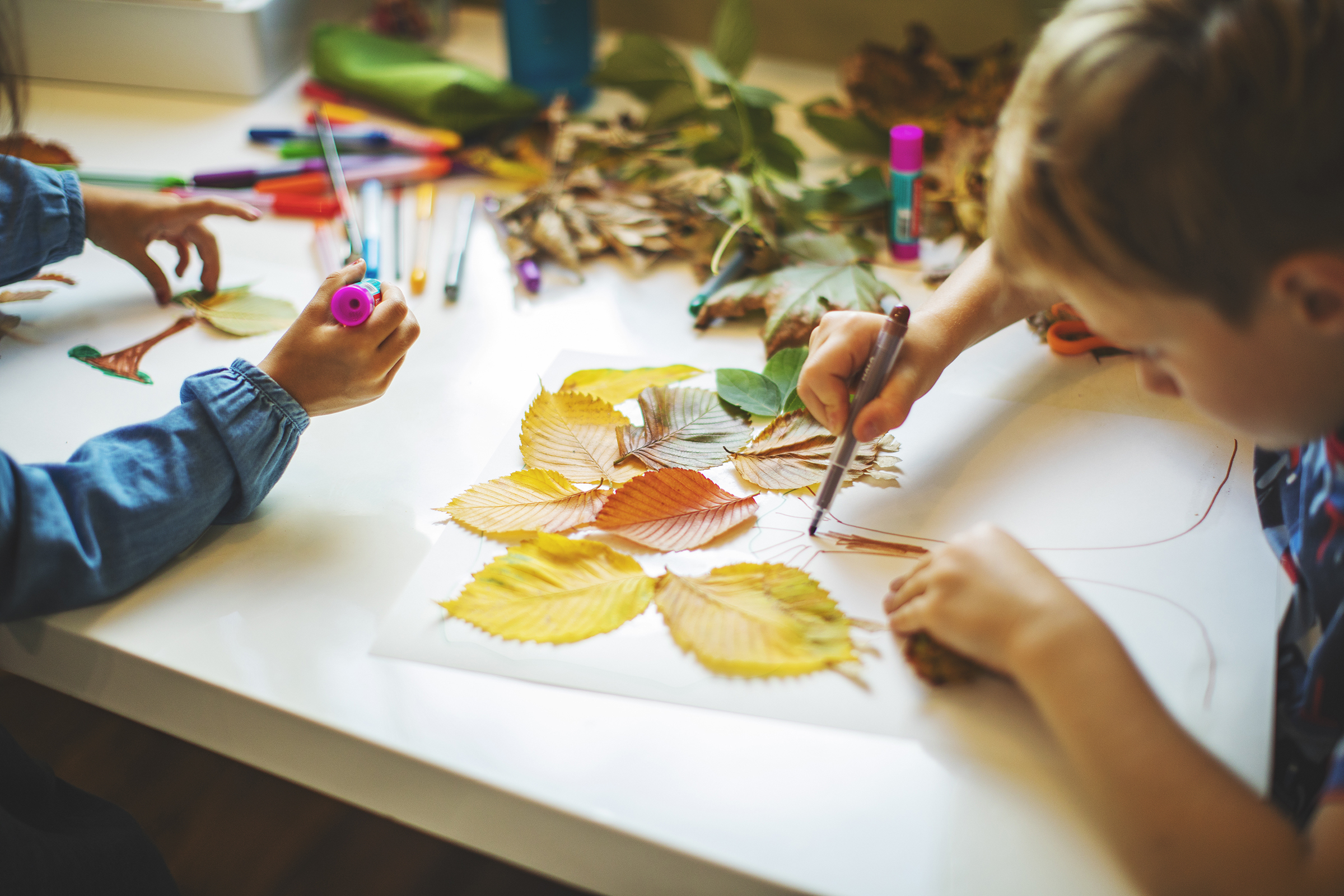 Children doing autumn handcrafts