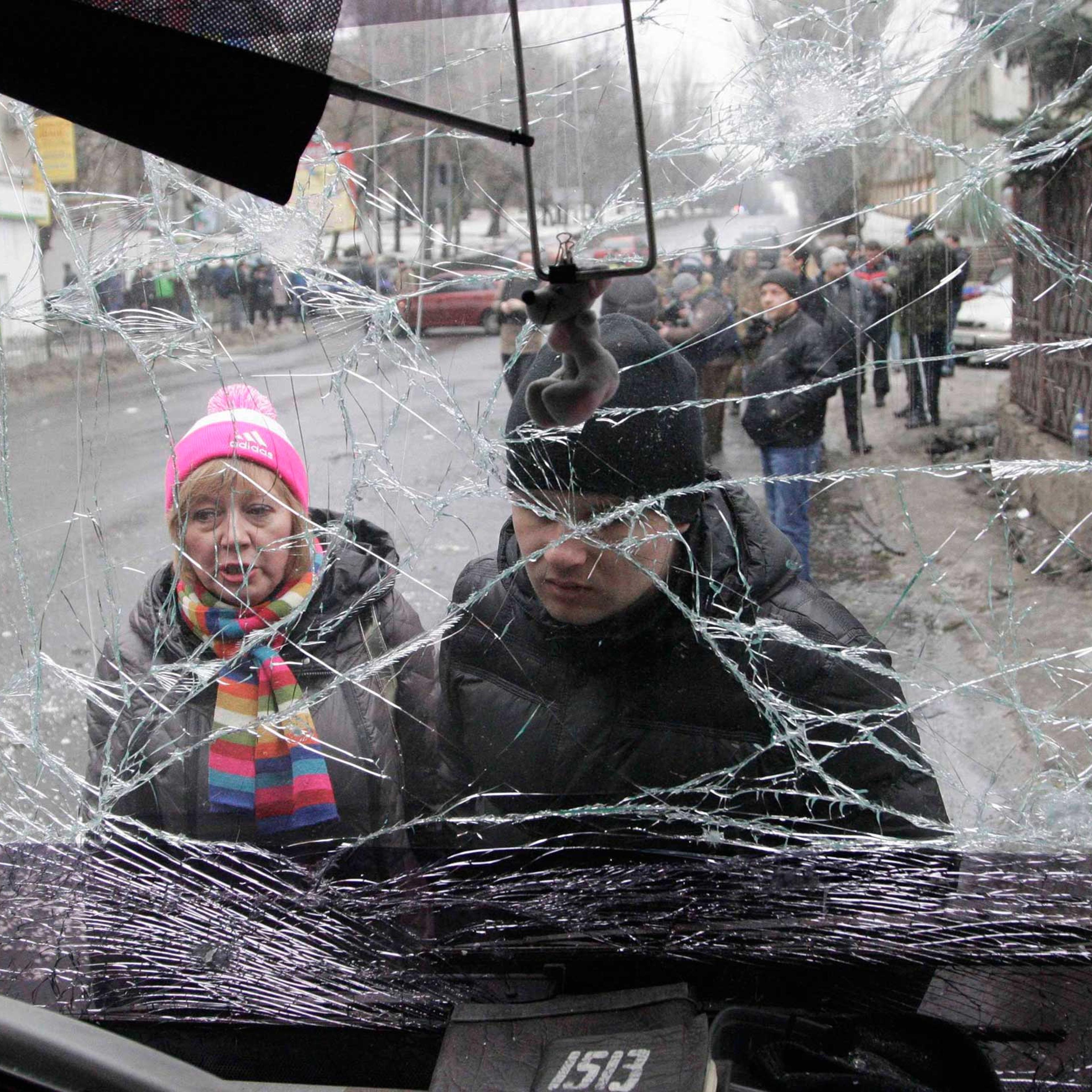 People look through the front windshield of a damaged trolleybus in Donetsk, Jan. 22, 2015.