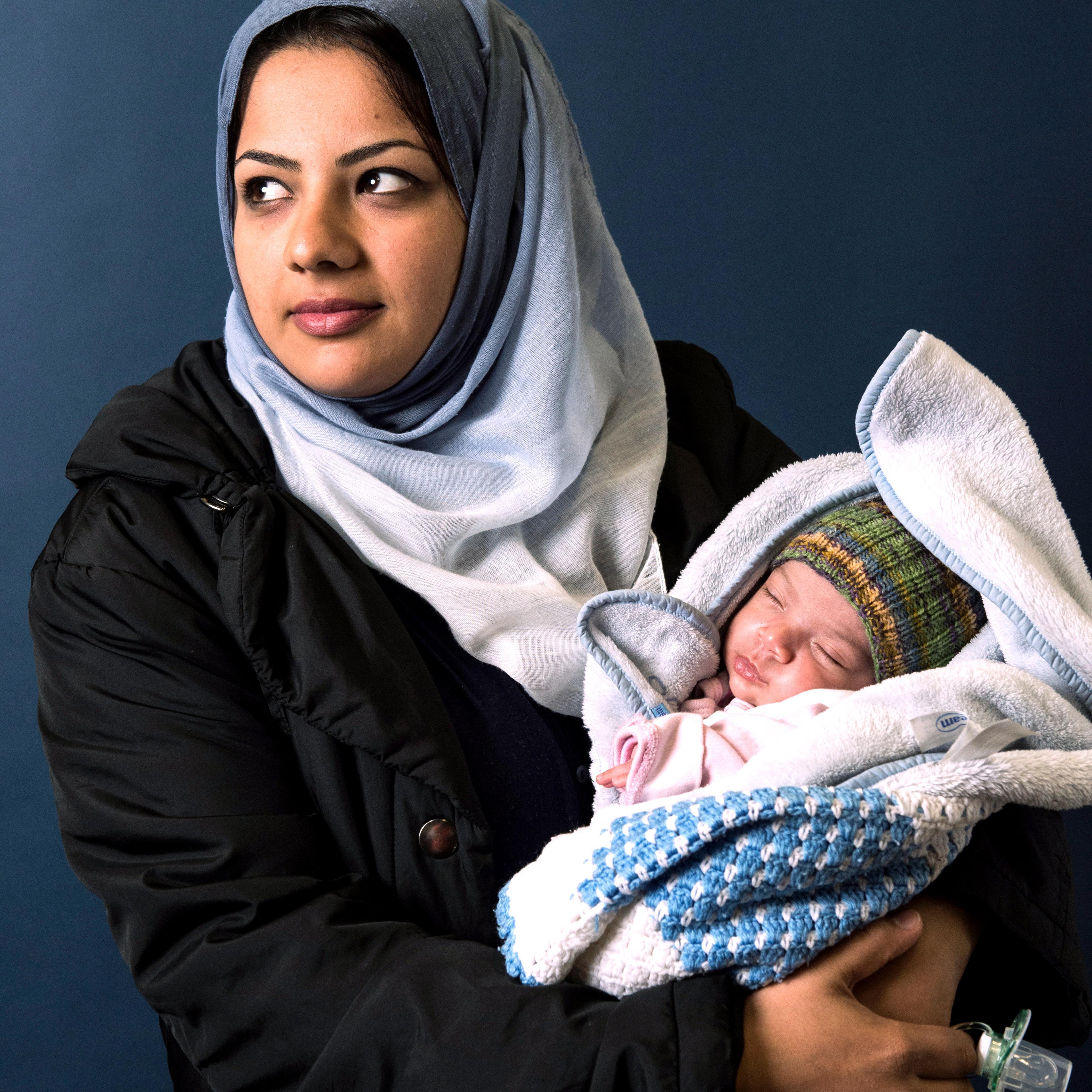 Hind Almahdawi, from Bagdad, poses with her infant daughter, Angela in Sarstedt, Germany on Nov. 4, 2015.