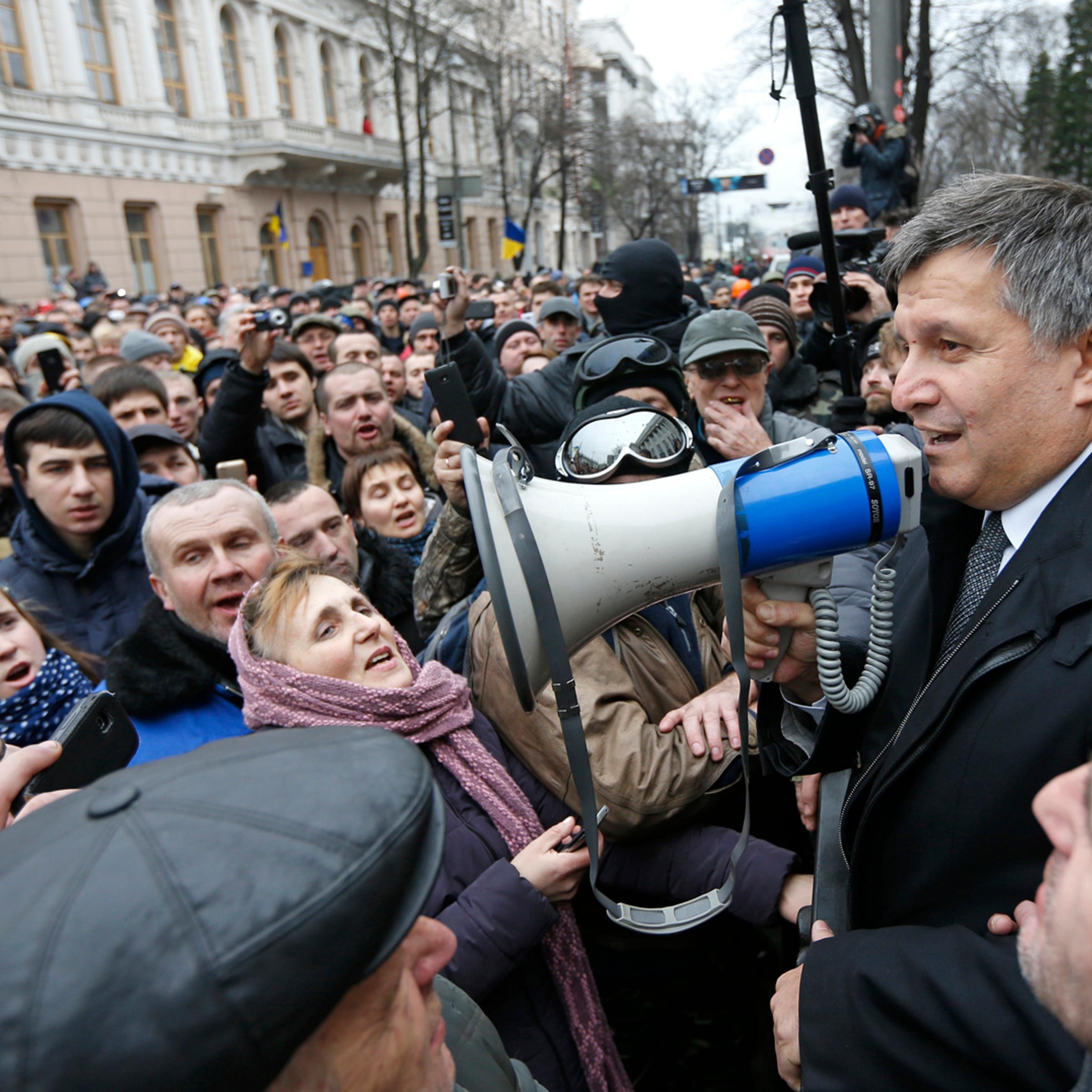 Newly elected Ukrainian interior minister Arsen Avakov holds a loud-speaker as he addresses anti-government protesters outside the Ukrainian parliament building in Kiev
