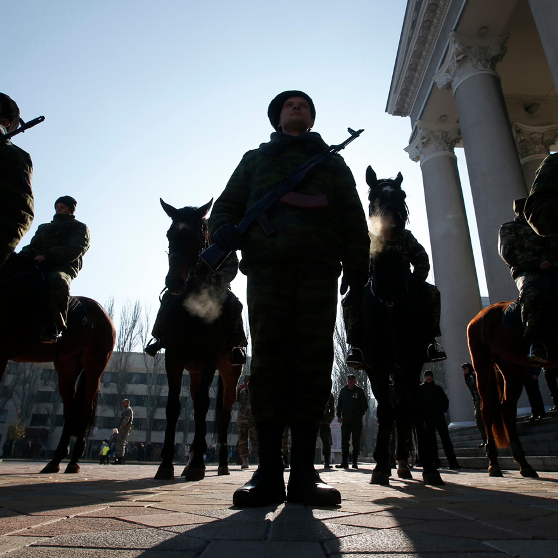 Members of an honour guard hold their weapons as they wait for the arrival of separatist leader Zakharchenko in front of a theatre in Donetsk
