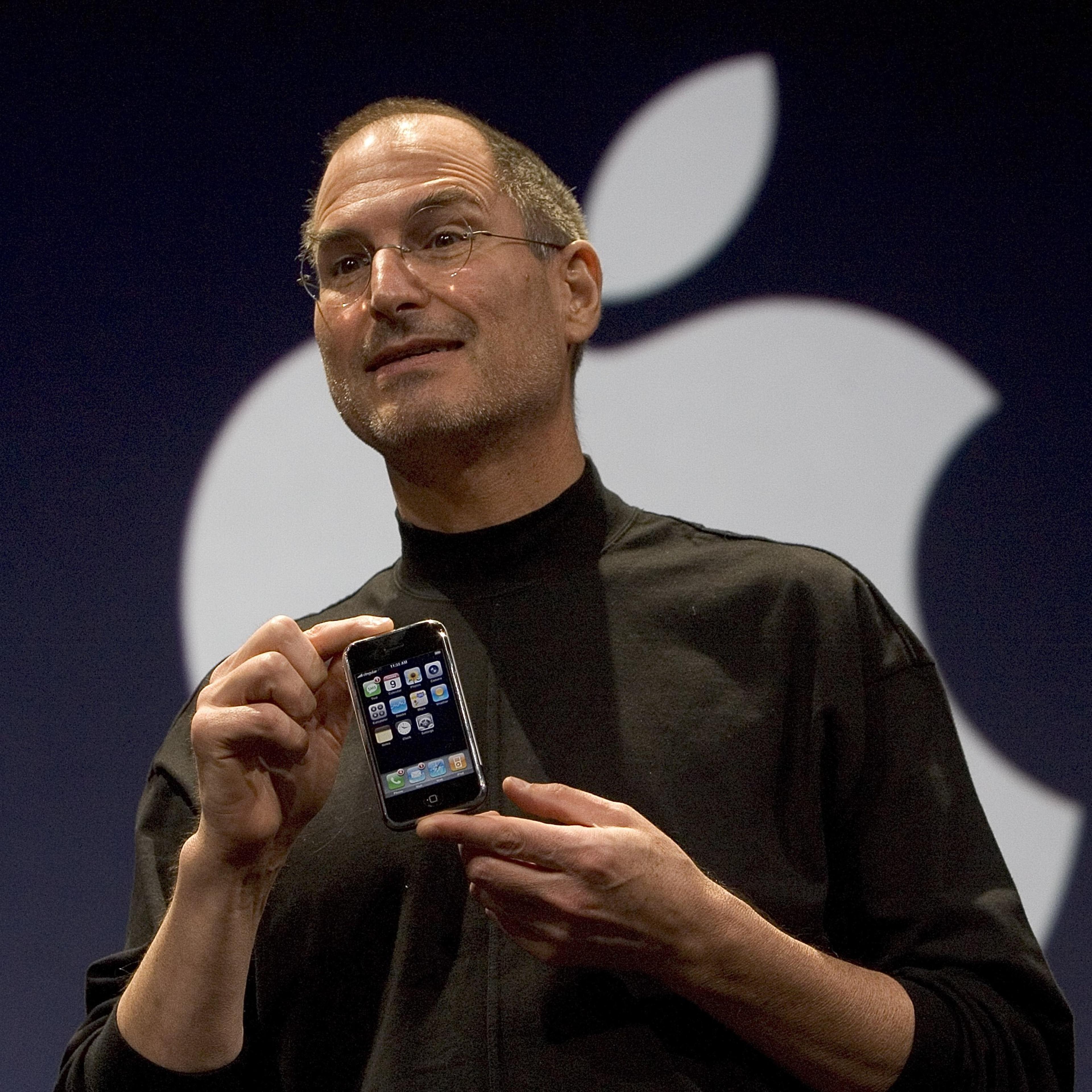 Apple CEO Steve Jobs holds up the new iPhone that was introduced at Macworld on January 9, 2007 in San Francisco.