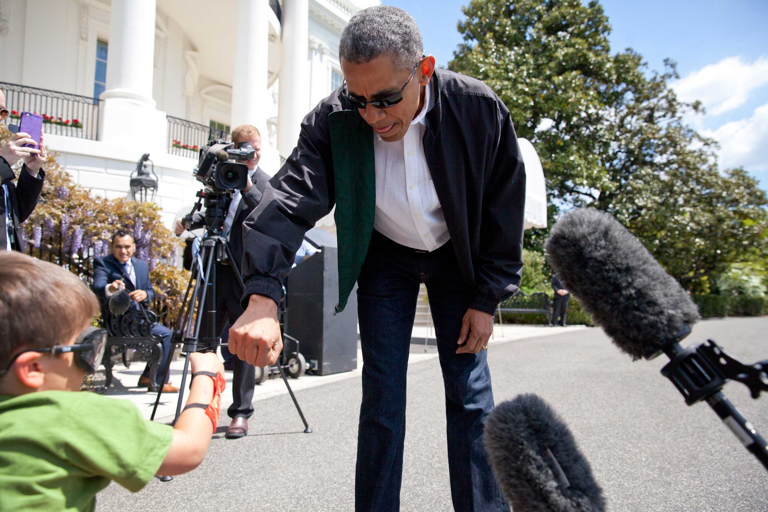 President Barack Obama greets Luca Martinez, 4, with a fist-bump as he walks from the White House to board Marine One in Washington on May 2, 2015.