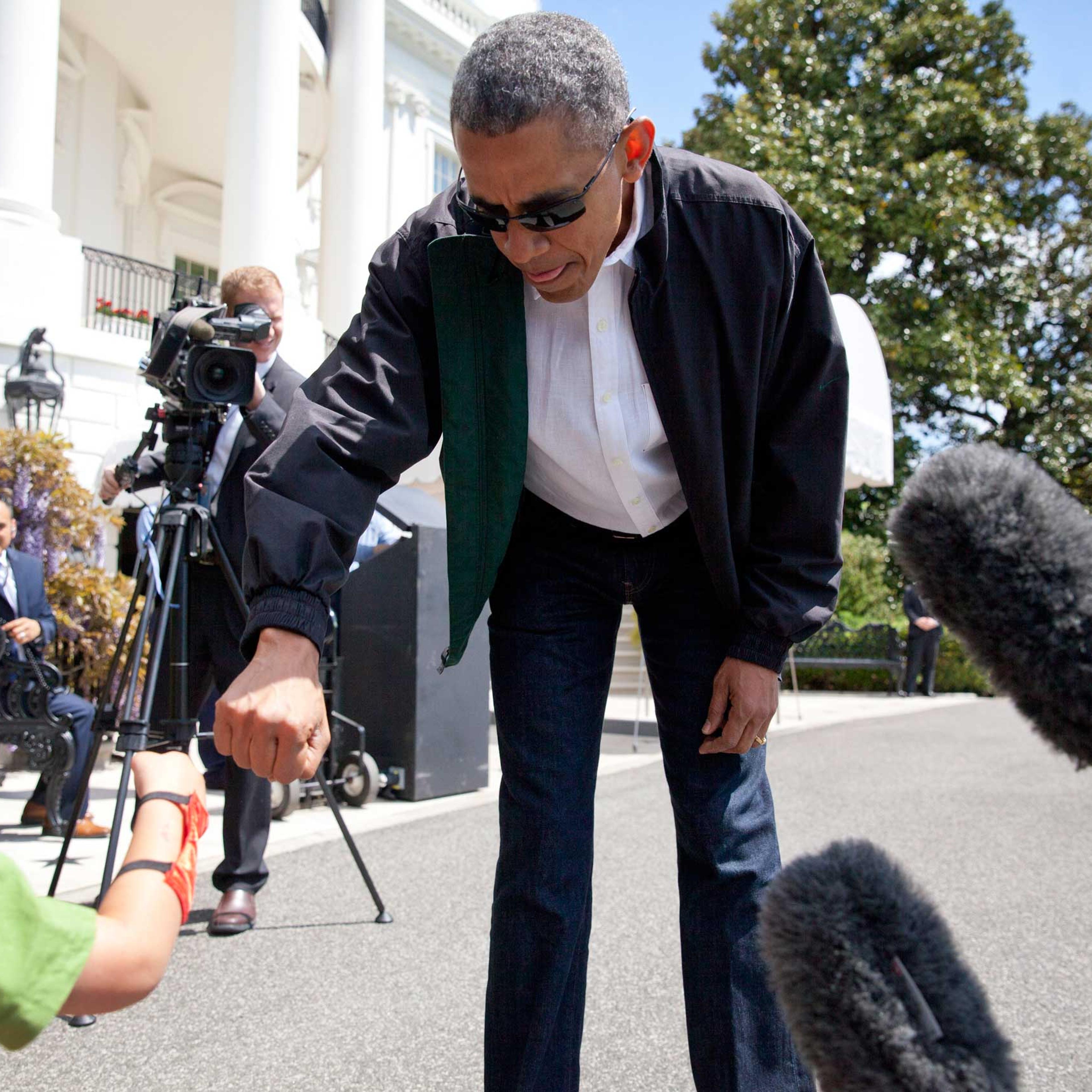 President Barack Obama greets Luca Martinez, 4, with a fist-bump as he walks from the White House to board Marine One in Washington on May 2, 2015.