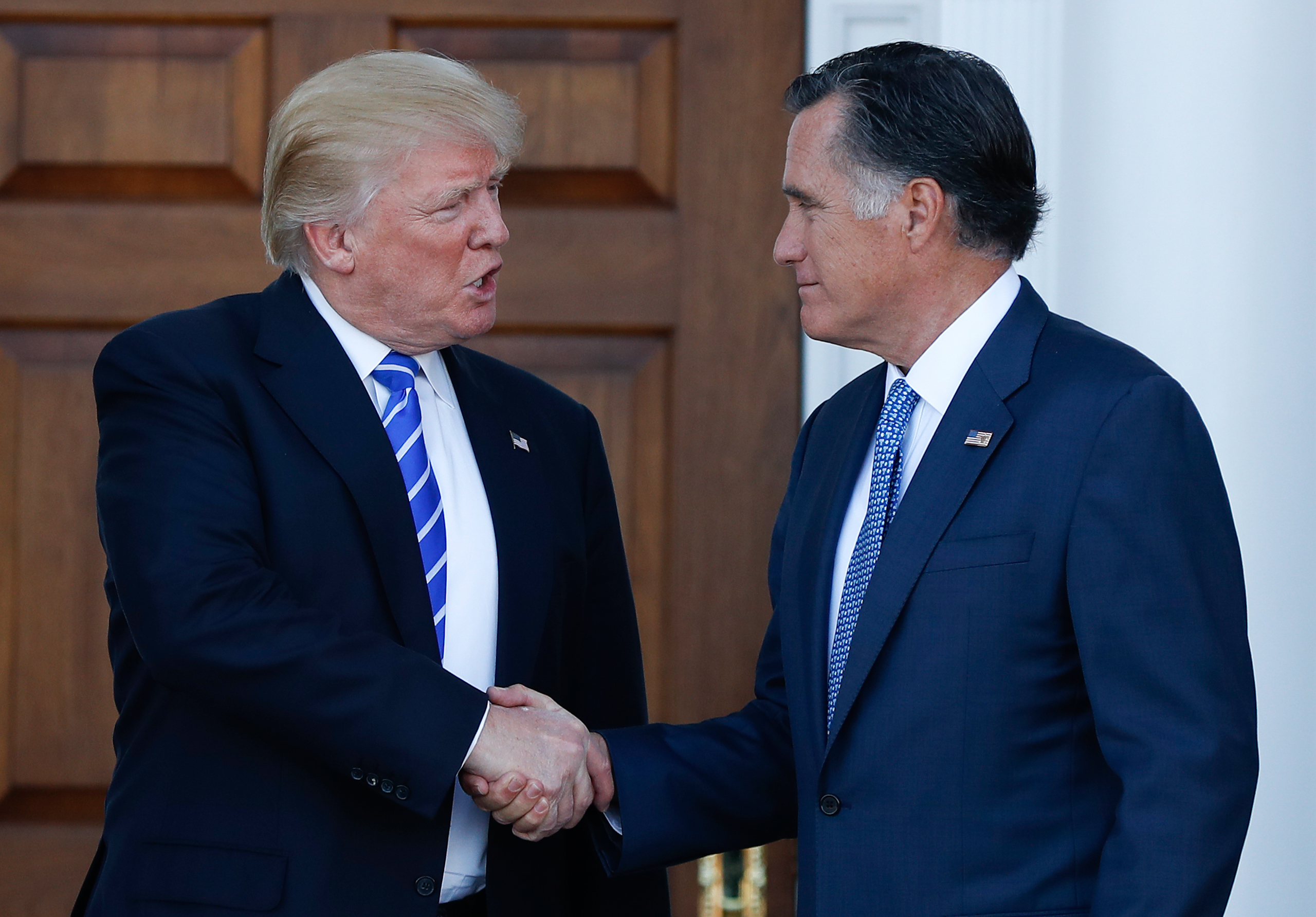 President-elect Donald Trump and Mitt Romney shake hands as Romney leaves Trump National Golf Club Bedminster in Bedminster, N.J., Saturday, Nov. 19, 2016. (AP Photo/Carolyn Kaster)