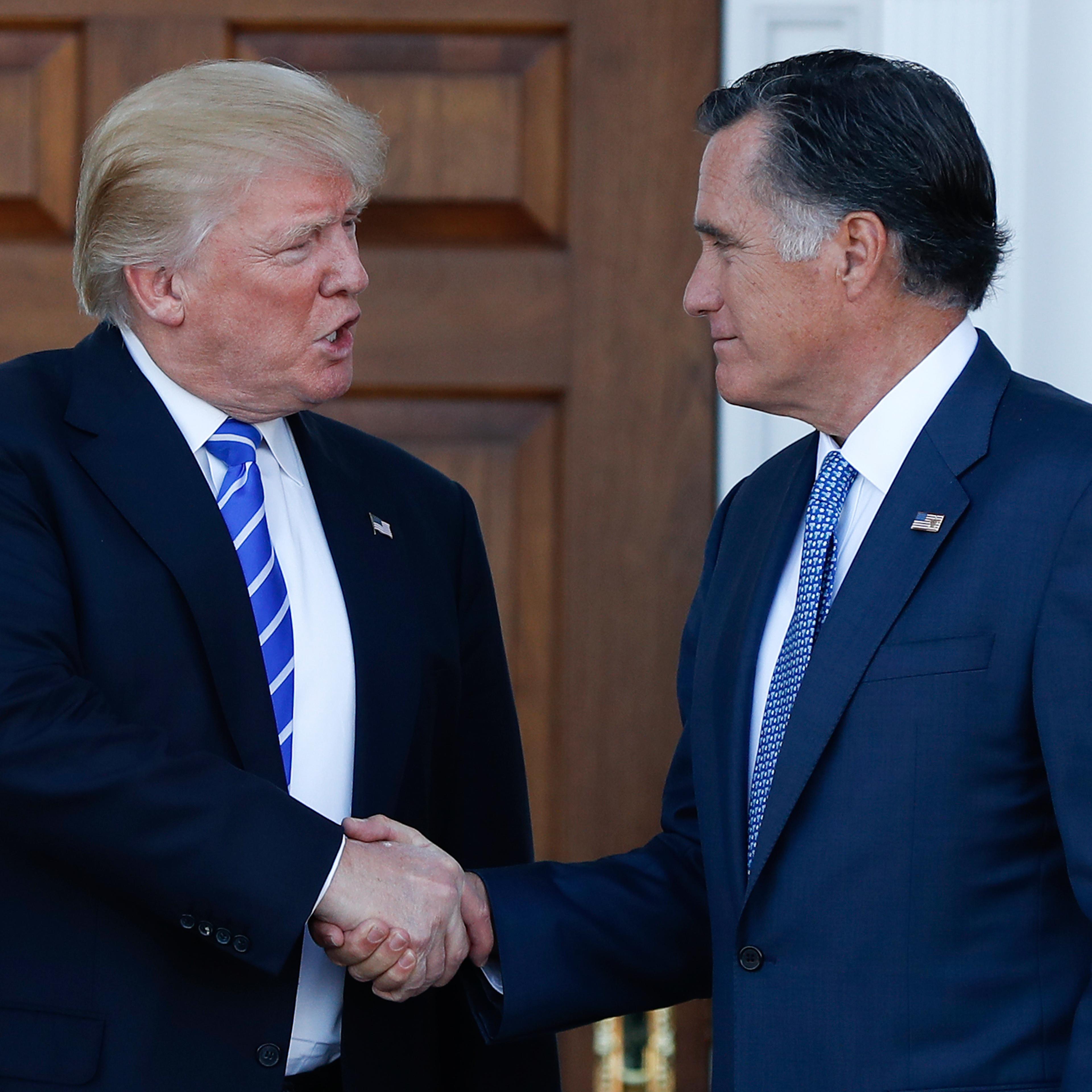 President-elect Donald Trump and Mitt Romney shake hands as Romney leaves Trump National Golf Club Bedminster in Bedminster, N.J., Saturday, Nov. 19, 2016. (AP Photo/Carolyn Kaster)