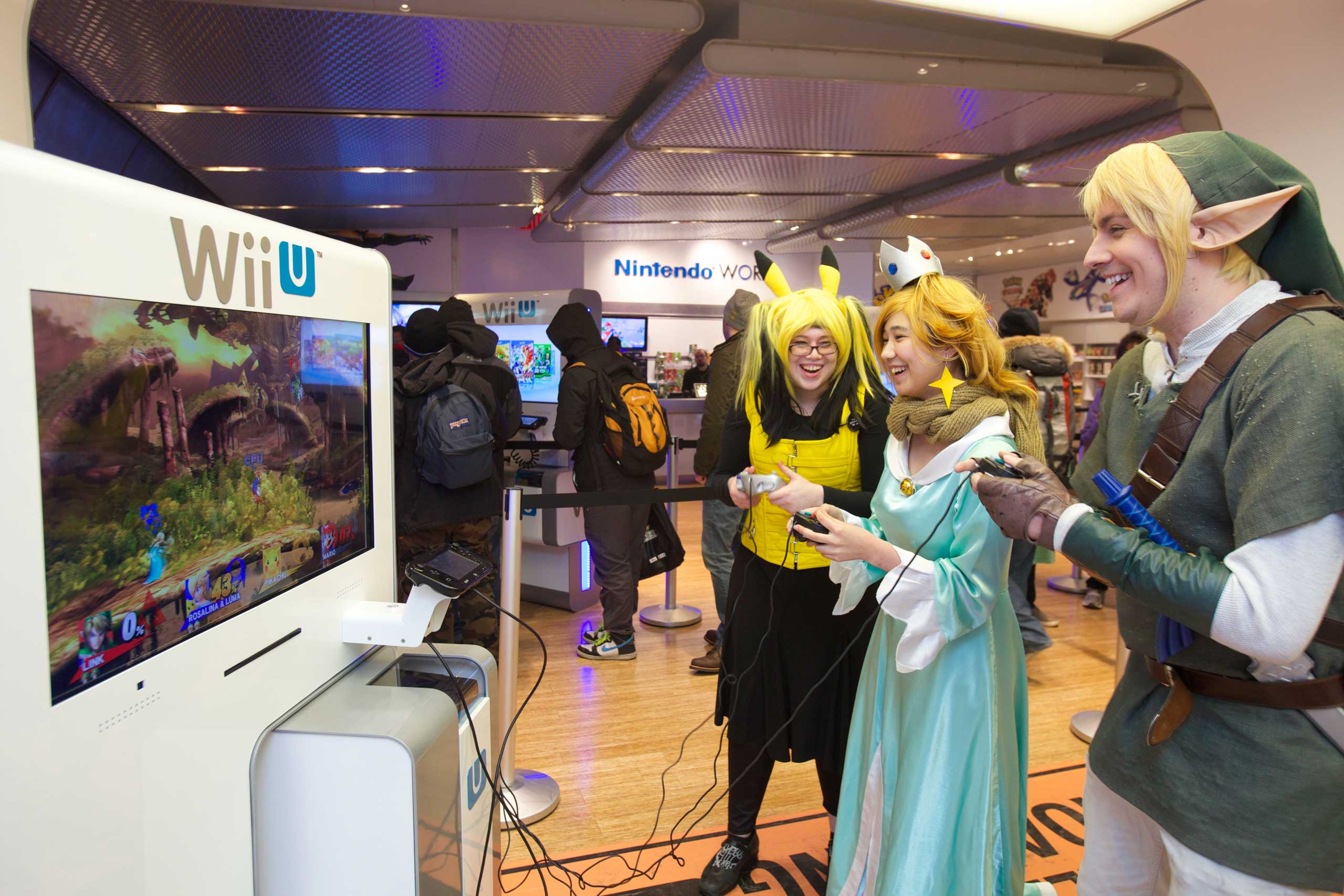 Left to Right: America, Elle M. Julia D., and Erich M. play the Super Smash Bros. for Wii U video game at the Nintendo World store launch event in New York on Nov. 20, 2014.
